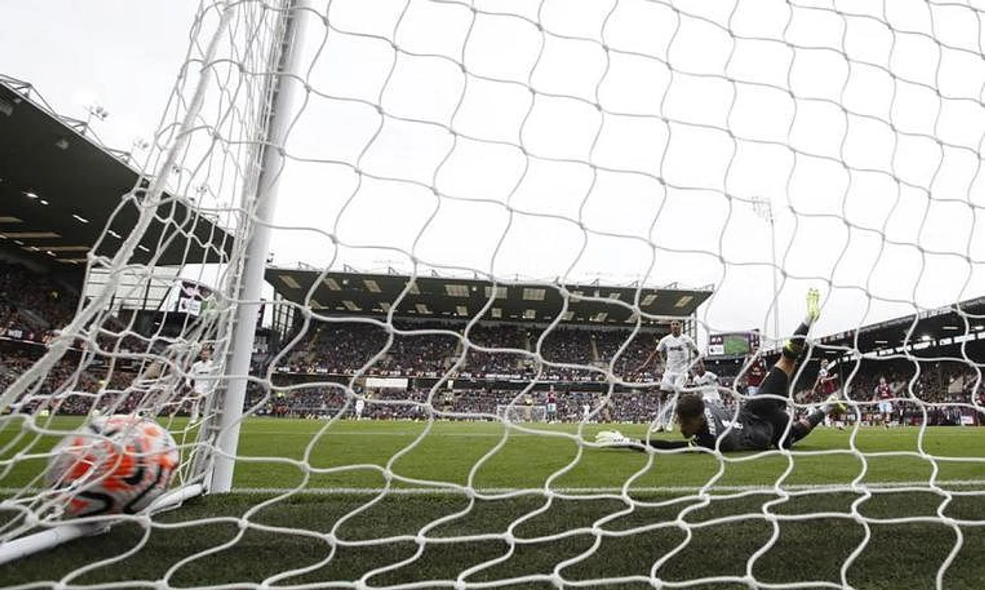 Soccer Football - Premier League - Burnley v Aston Villa - Turf Moor, Burnley, Britain - August 27, 2023 Aston Villa's Moussa Diaby scores their third goal past Burnley's James Trafford REUTERS/Molly Darlington