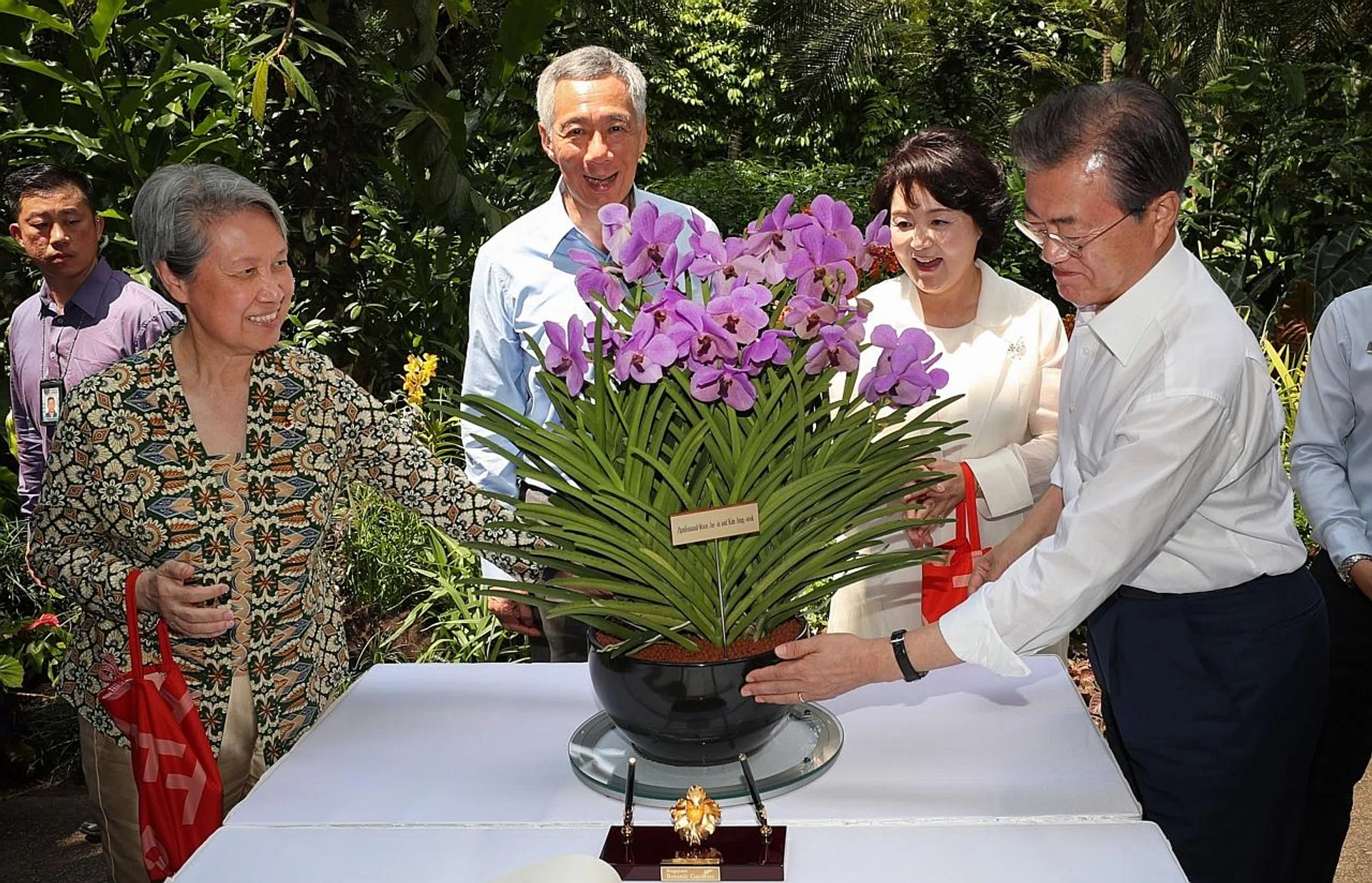 (From right) South Korean President Moon Jae In, his wife Kim Jung Sook, Prime Minister Lee Hsien Loong and his wife Ho Ching taking part in an orchid naming ceremony at the Singapore Botanic Gardens. 