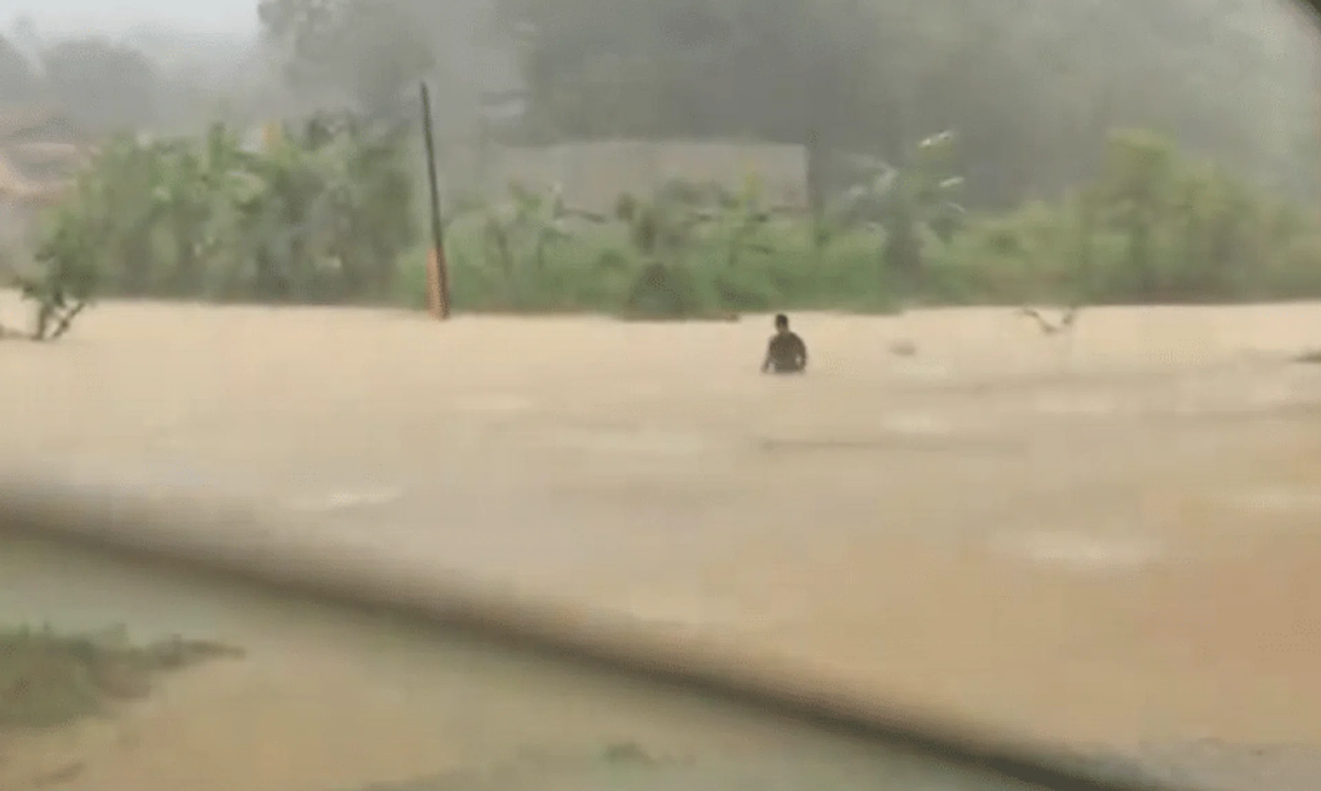 The father trudged through murky flood waters to get baby essentials.