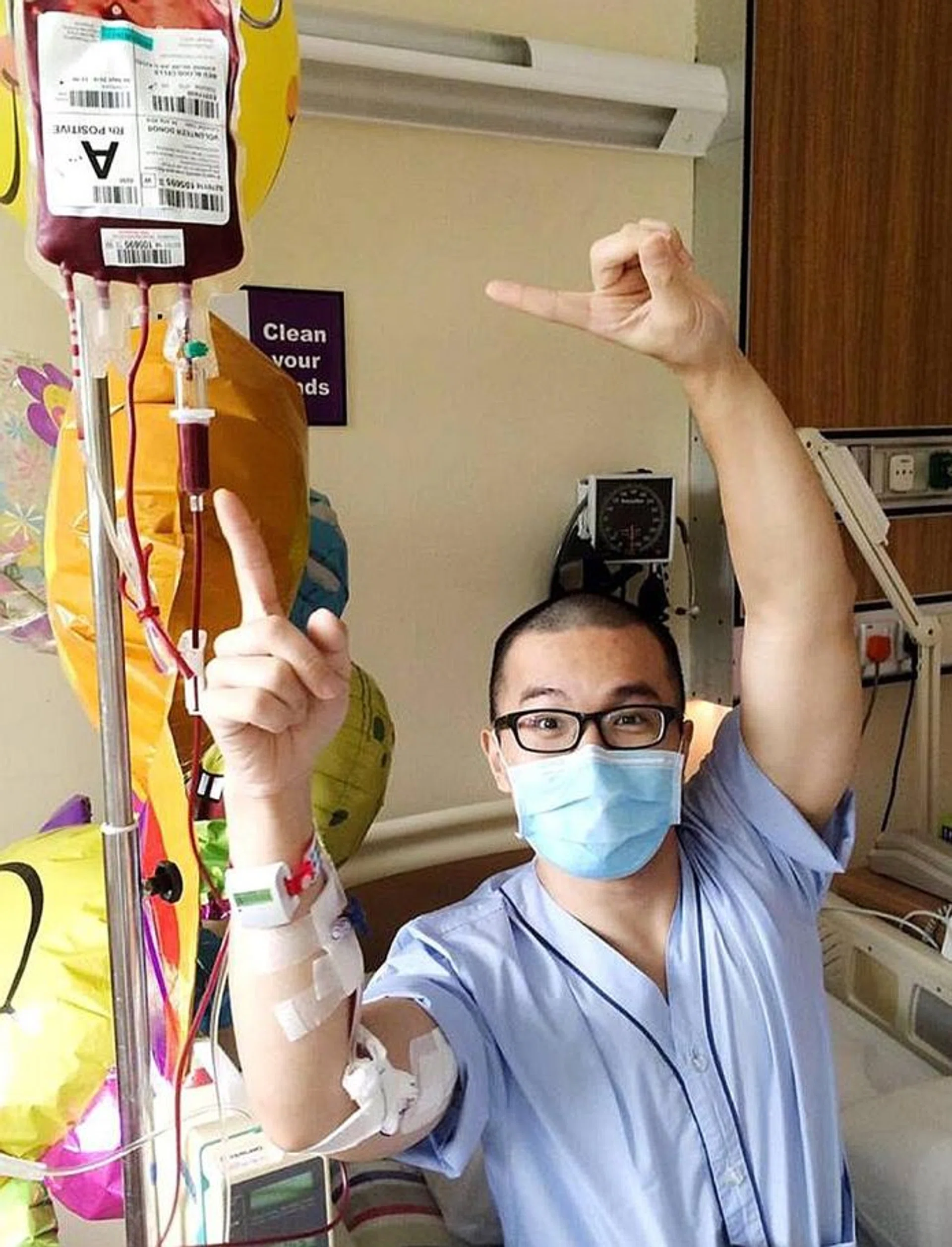 HAPPY: Mr Edwin Chen poses with his IV drip in his ward.