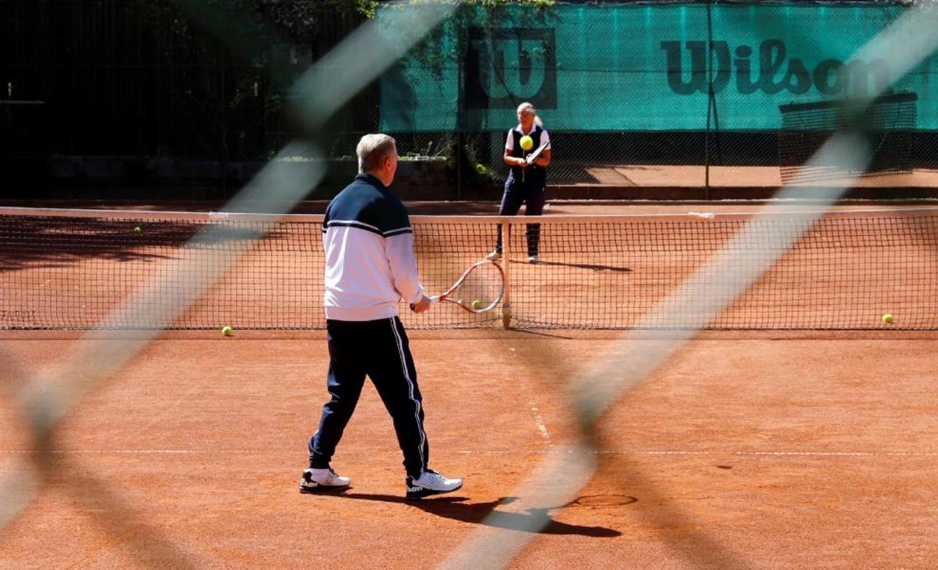 An elderly couple playing tennis at the Smashing Suns club, after the Austrian government last Friday loosened a seven-week lockdown due to the Covid-19 outbreak.