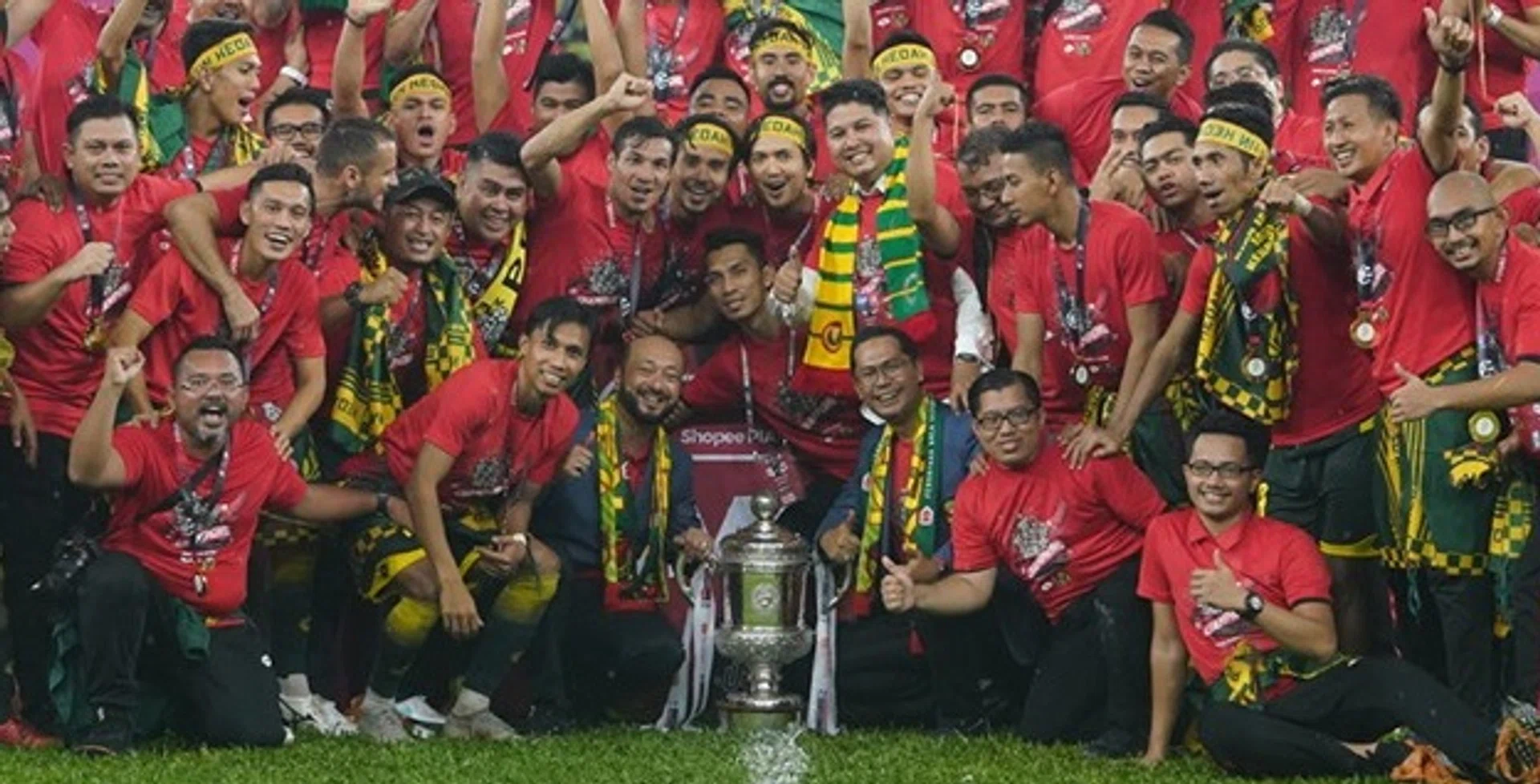 Coach Aidil Sharin (second row, centre, with scarf) celebrating with the Kedah squad after their win over Perak in the Malaysian FA Cup.