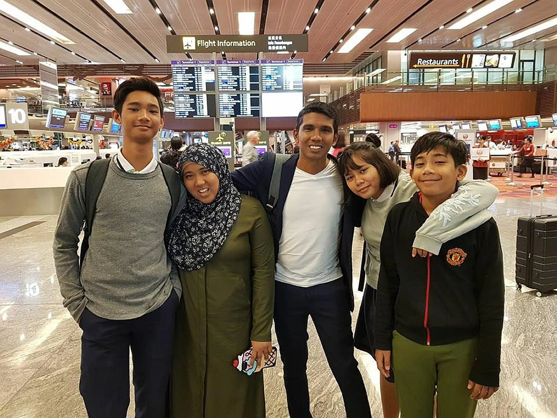 Former Singapore international Noor Ali, seen above with his family, and Firdaus Kassim looking to gain valuable experience from their overseas coaching stints. 