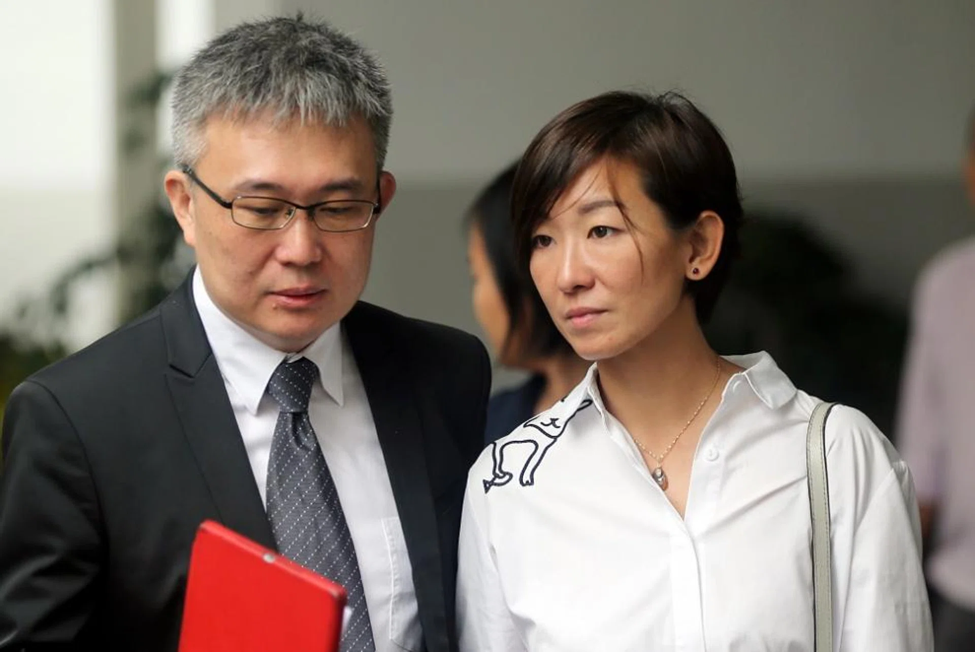  Mr Spencer Tuppani’s wife Ms Shyller Tan Cheng Cheng with a lawyer.