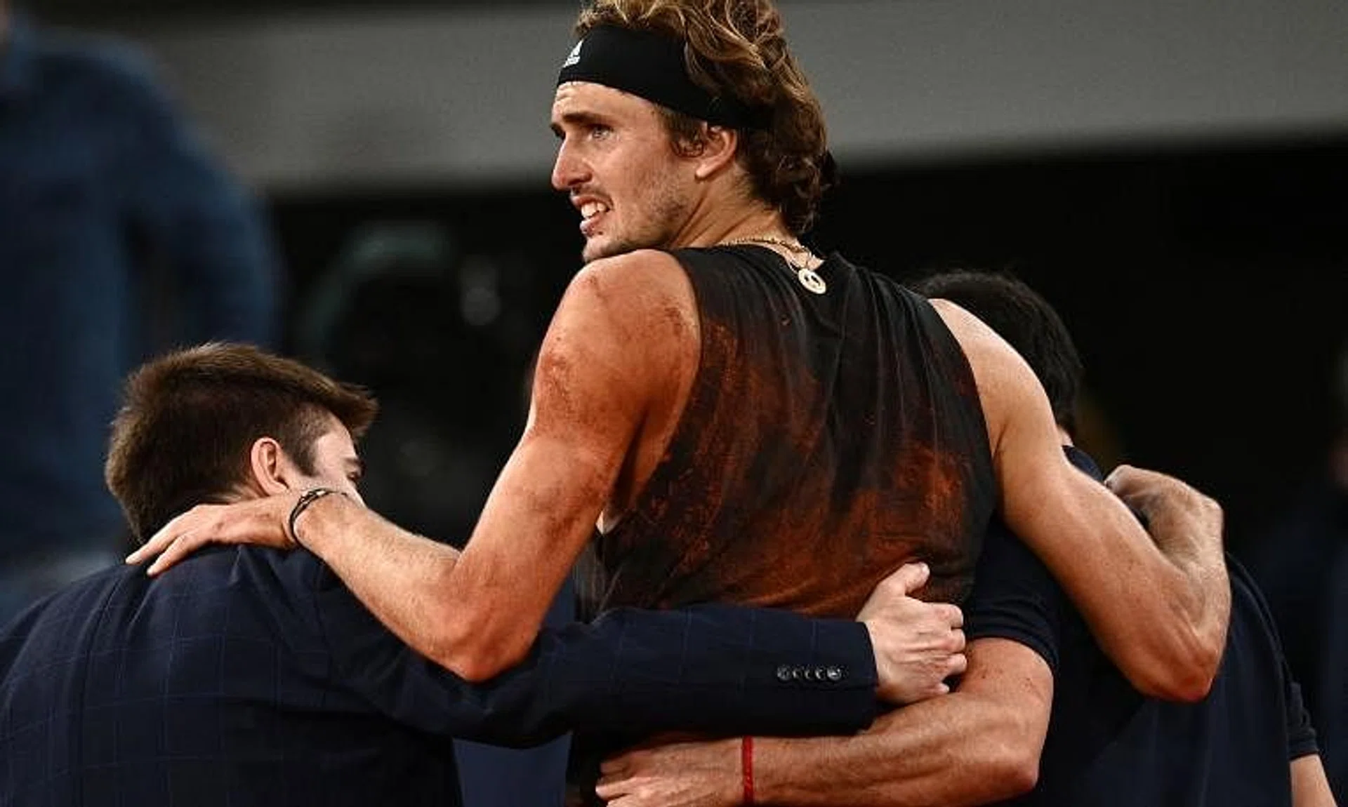 Germany's Alexander Zverev (centre) is helped as he leaves the court, after being injured during his match against Rafael Nadal.