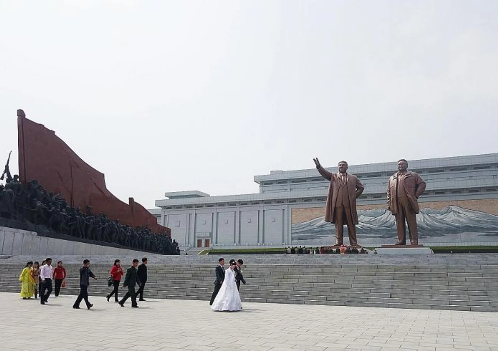 BRIDE & GROOM: A local couple having their bridal shoot in front of the giant bronze statues of Kim Il Sung and Kim Jong Il.