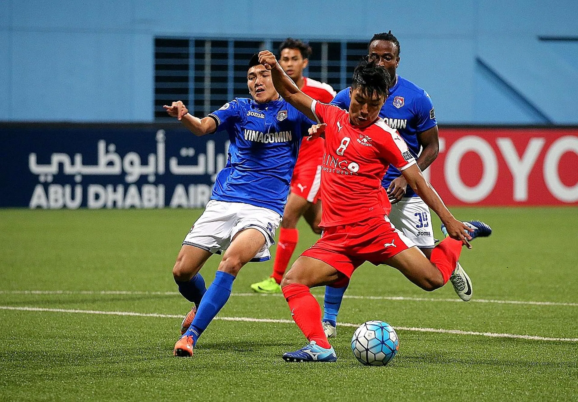 Home United's Song Ui Young (in red) drawing first blood despite the attention of Than Quang Ninh's Duong Van Khoa (left) and Geoffrey Kizito. TNP PHOTO: PHYLLICIA WANG