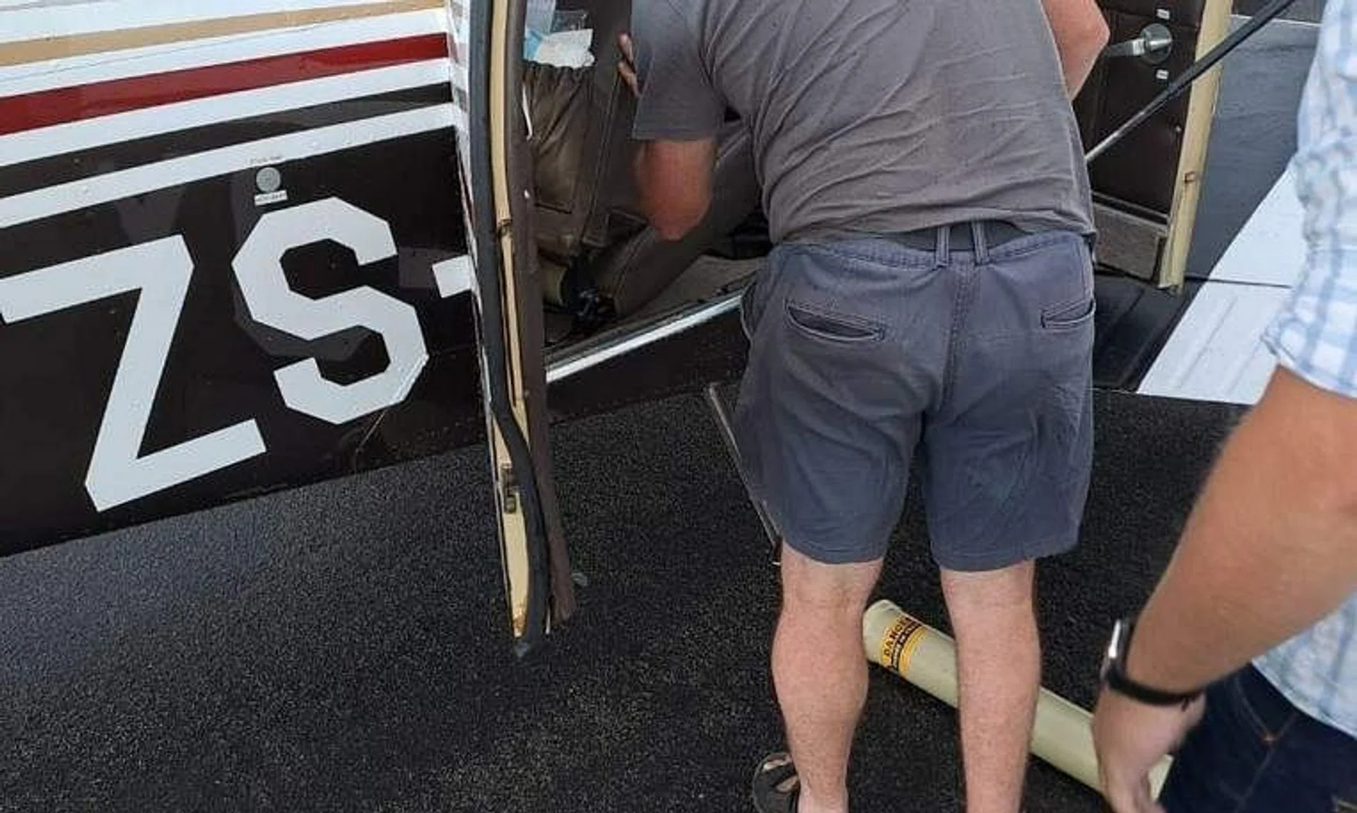 A snake catcher looking for the Cape cobra in the Beechcraft Baron 58 aircraft.