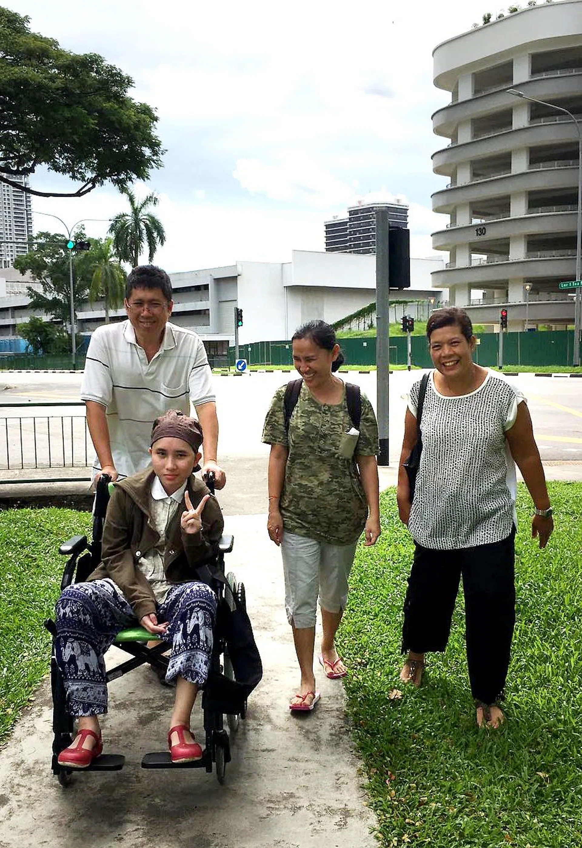 Thai teenager Aroonrak Jattanathammajit, who has been in hospital the past two months, on a rare outing with her parents.