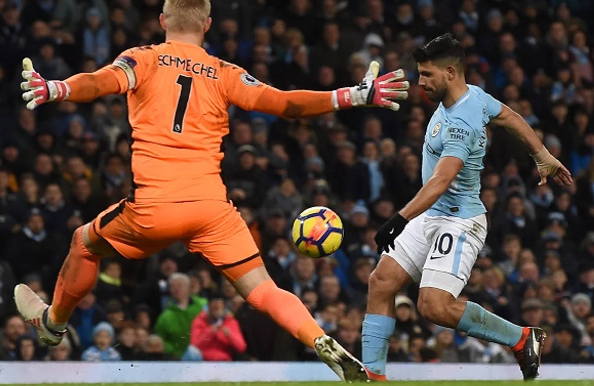 Sergio Aguero (right) chipping the ball over Leicester goalkeeper Kasper Schmeichel for his side's fourth goal and his third in their 5-1 win.