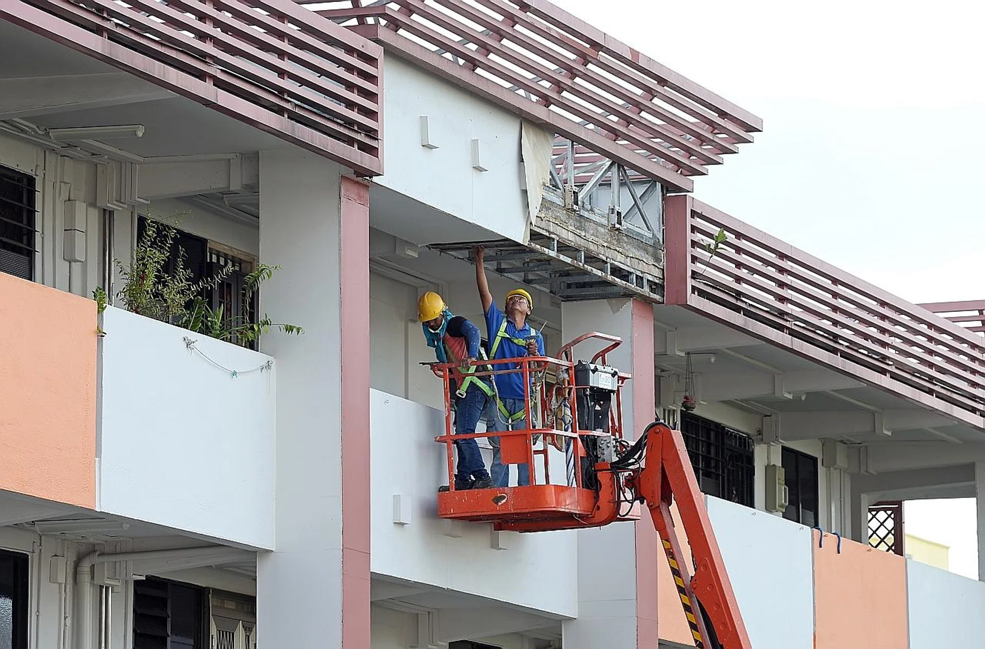 Contractors seen carrying out repair works at the top floor ceiling of Block 9, Toa Payoh Lorong 7. 