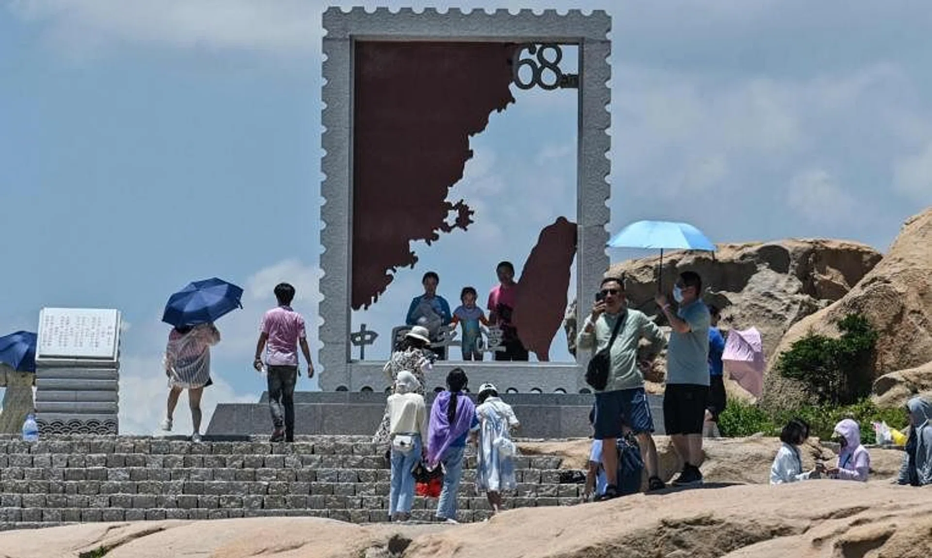 Tourists stand in a scenic area in Pingtan Island, China, on Aug 4, 2022.