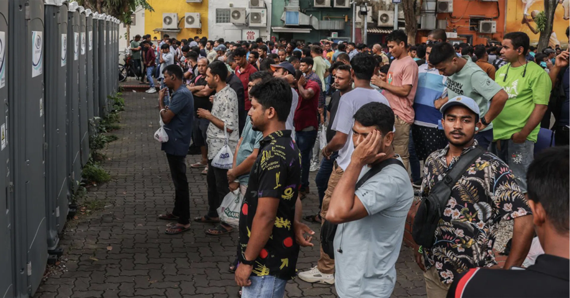 Long queues to use a row of portable toilets in Lembu Road on a busy Sunday in Little India. 