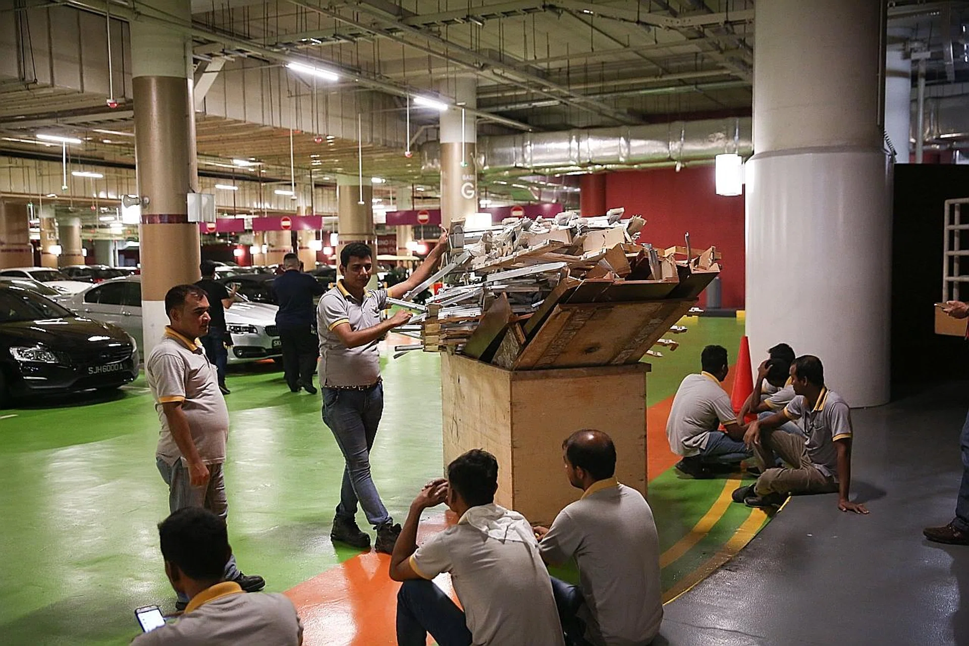Workers clearing up debris from the incident, in which three renovation workers and a security officer were injured. 