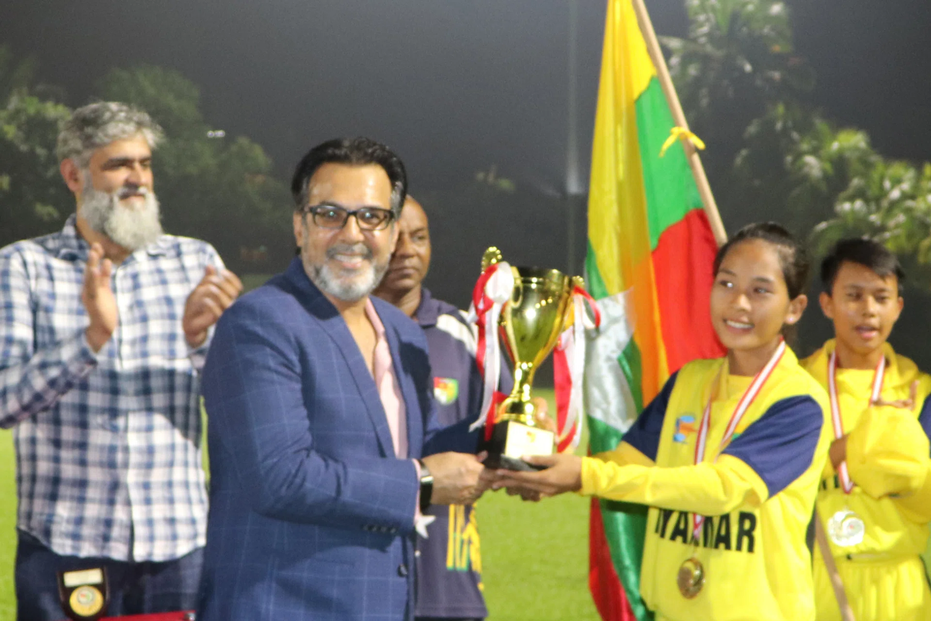 SCA president Mahmood Gaznavi handing the trophy to Myanmar captain Zar Lin Win.  