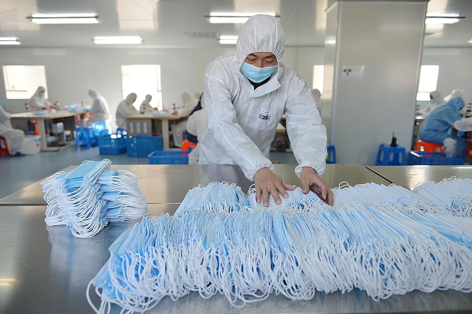 A worker at a factory in Nanjing sorting face masks as production ramps up to meet demand. 