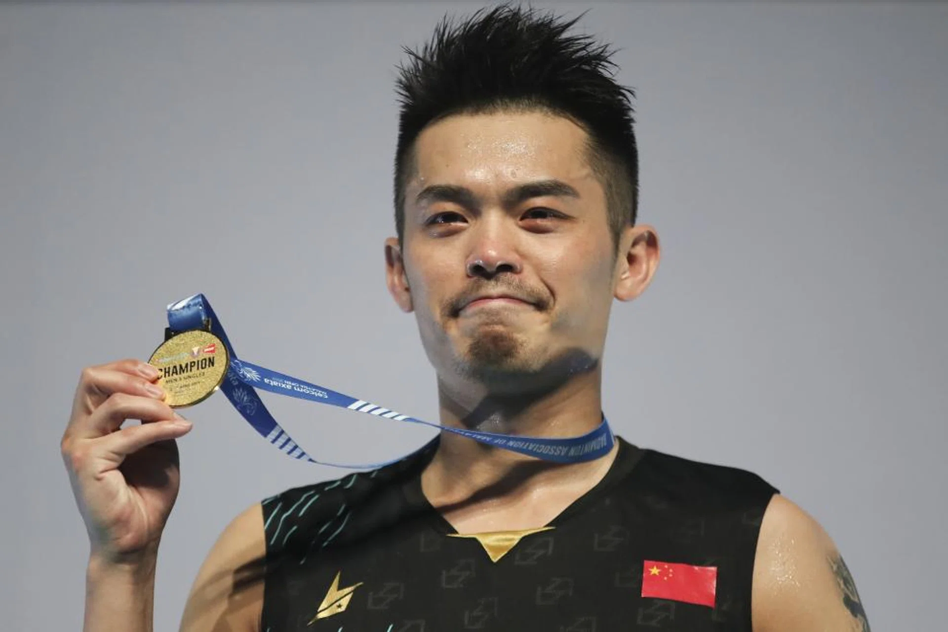 Lin Dan showing his Malaysia Open winner's medal with pride.