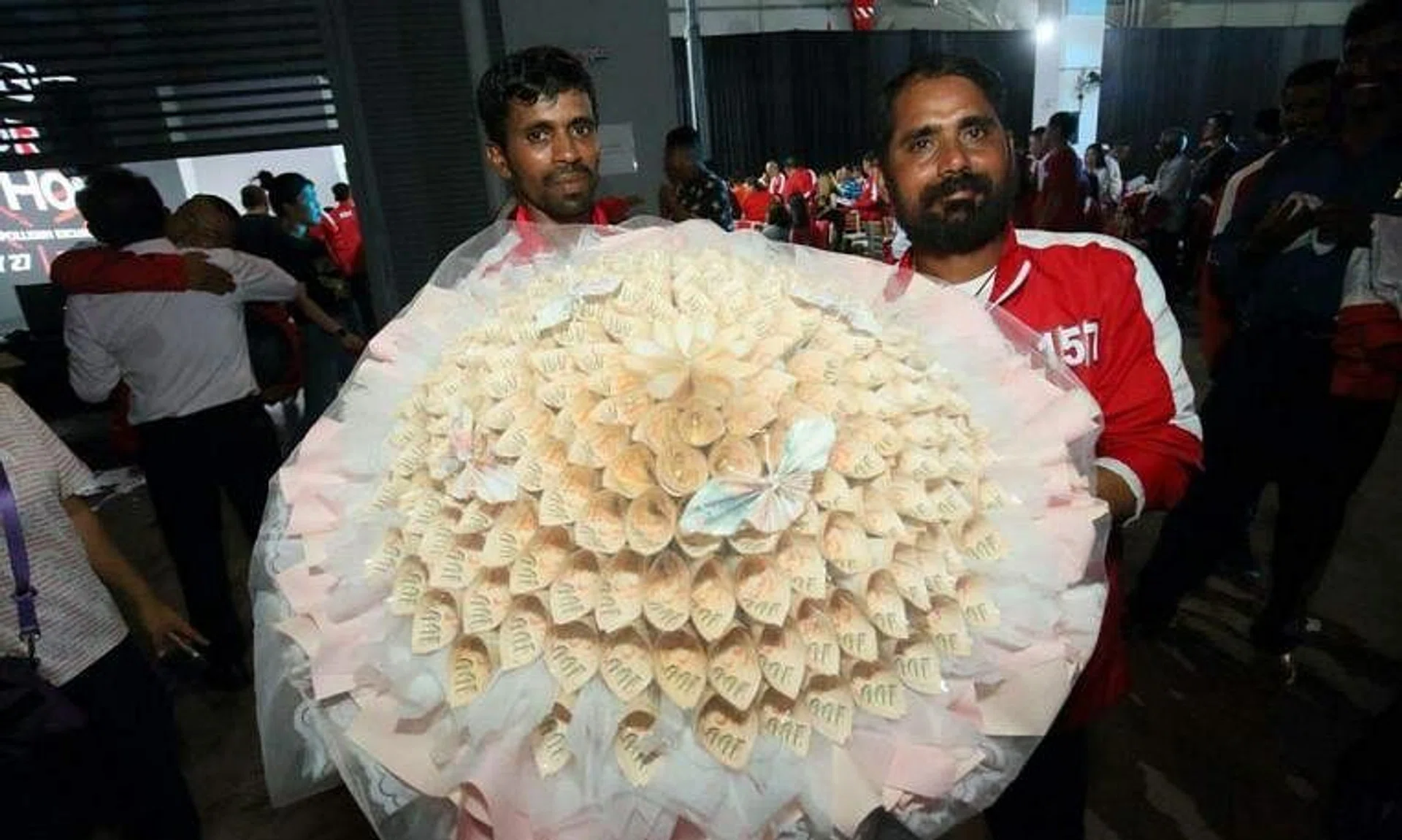 Mr Selvam Arumugam (right) said he will use the prize money to build a family home in India.