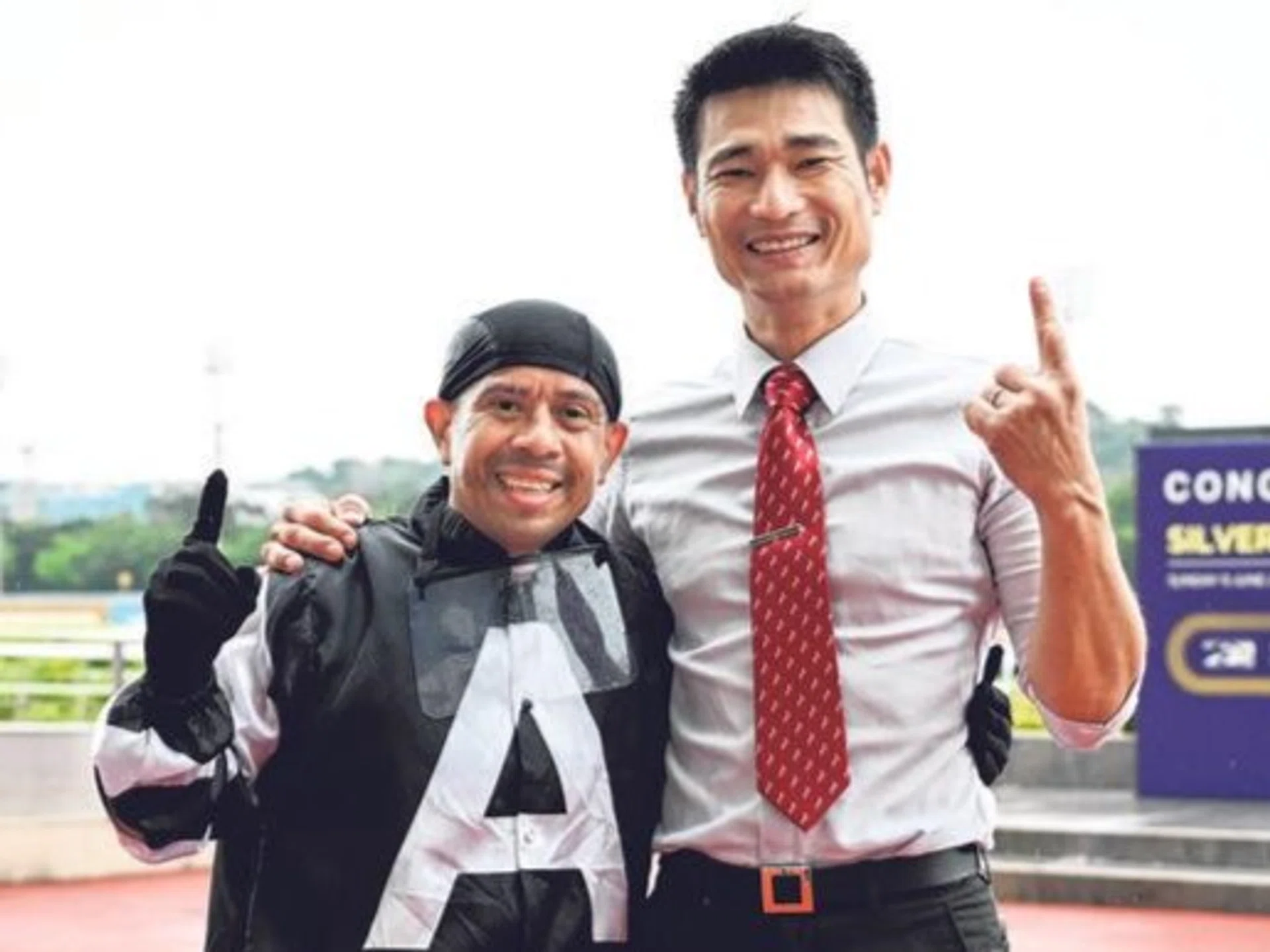 Panamanian jockey Luis Corrales and trainer Richard Lim showing their delight after combining with Combustion to take the Class 5 Division 1 race (1.600m) at Kranji on June 1.
