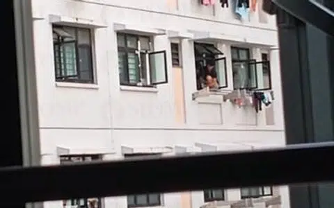 Woman in Yishun balances dangerously on windowsill