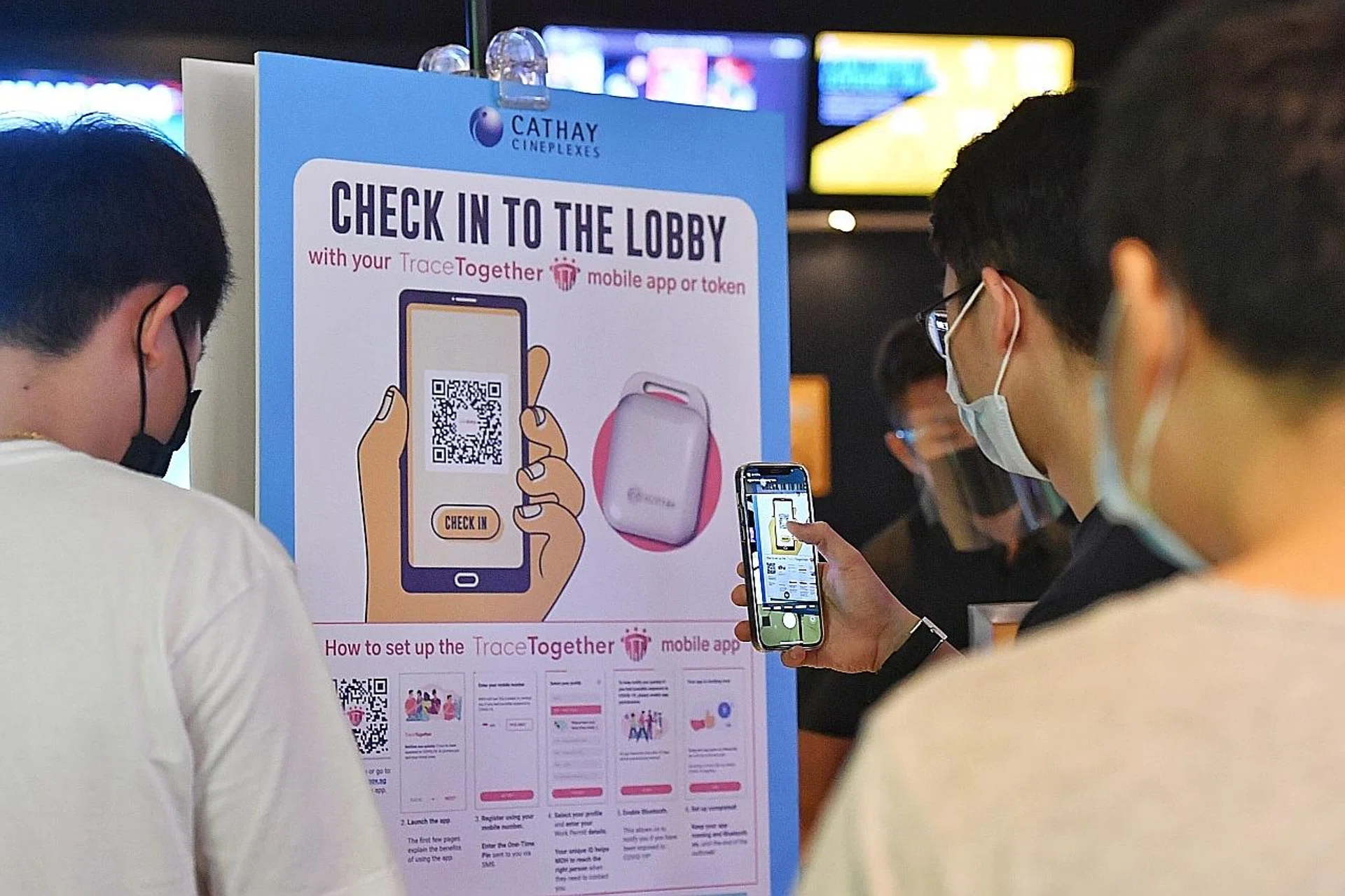By the end of this month, checking in with the TraceTogether app or token will be mandatory at public venues. TNP FILE PHOTO