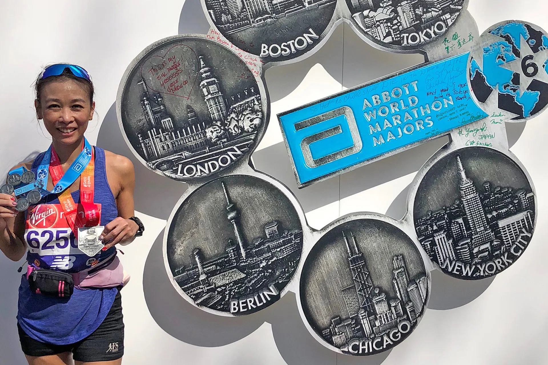 Laura Koh showing her medals after completing her sixth World Marathon Major at the London Marathon last year. 