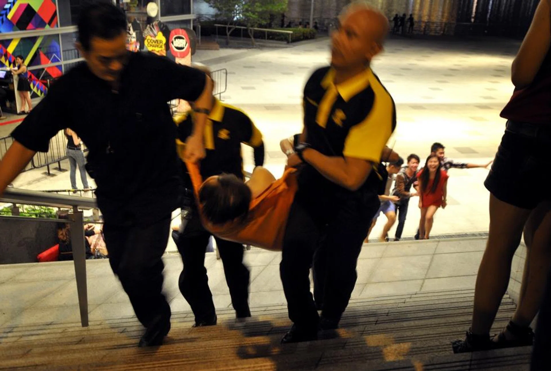 A drunk clubber being carried away on a stretcher after collapsing.