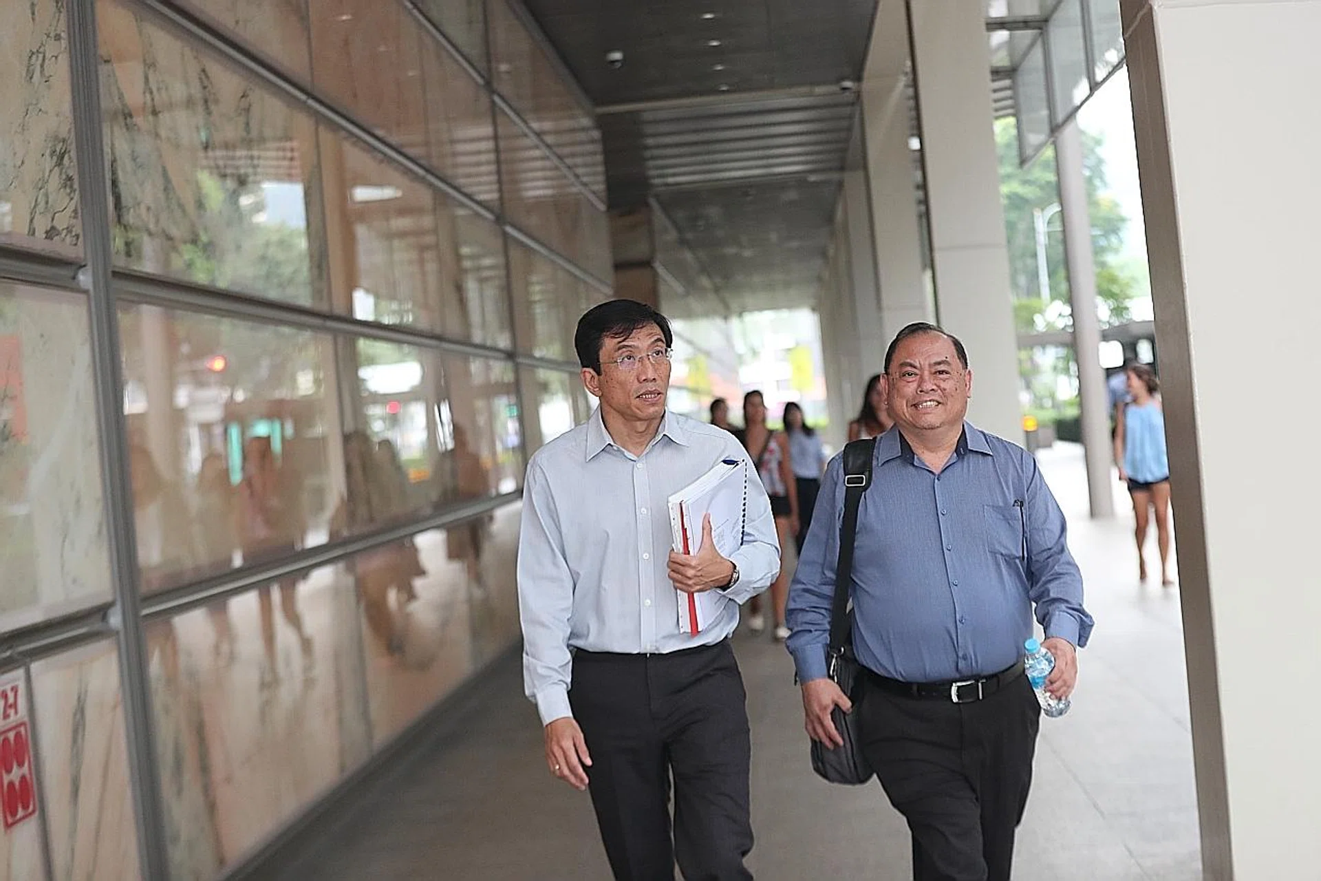 (From left) SDP secretary-general Chee Soon Juan with the party's vice-chairman John Tan leaving court. 