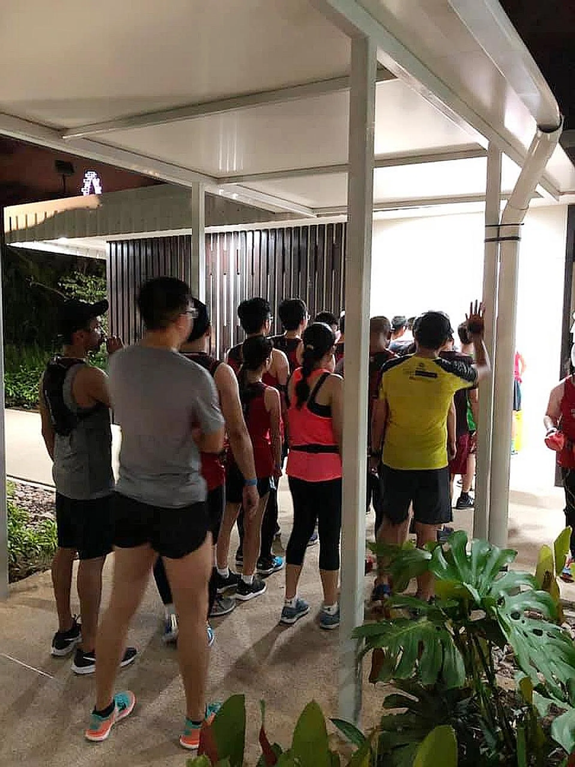 Runners queue for the public water coolers at Gardens by the Bay East. 