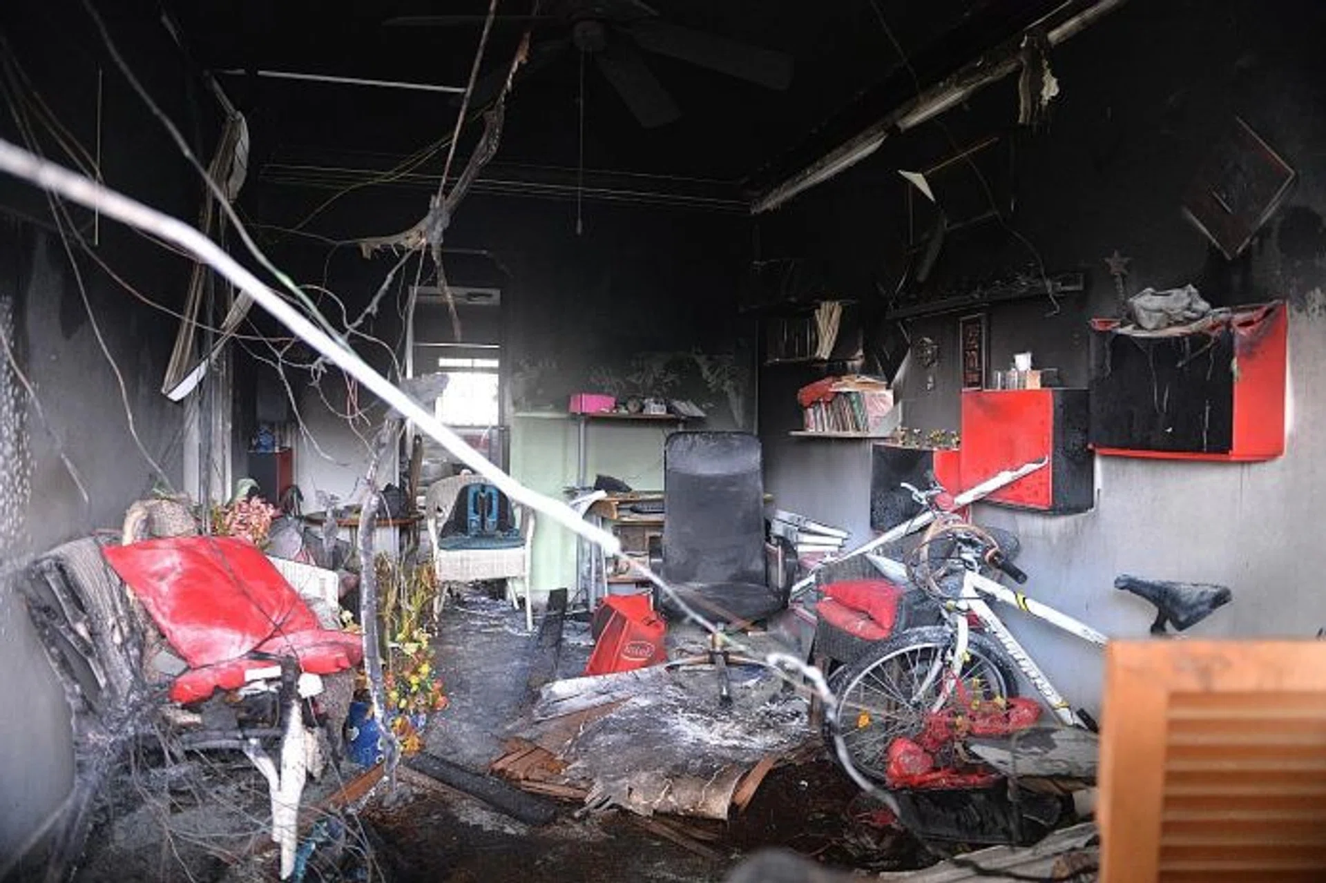 GONE: (Above) The walls of the living room and its contents were charred. The police have classified the fire as a case of unlicensed money-lending harassment.