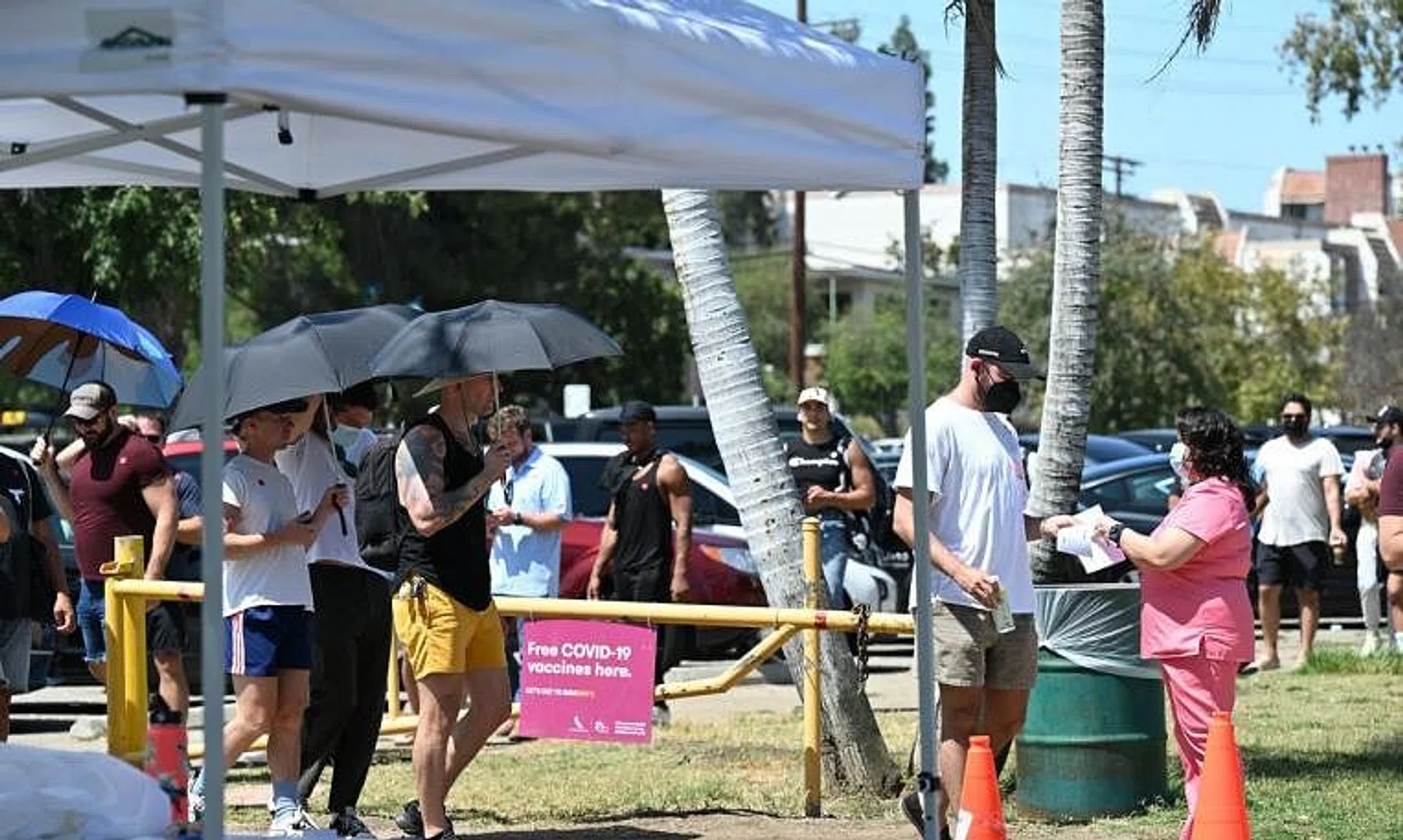 People wait to receive the monkeypox vaccine at the Balboa Sports Center, Encino neighborhood, Los Angeles, on July 27, 2022.