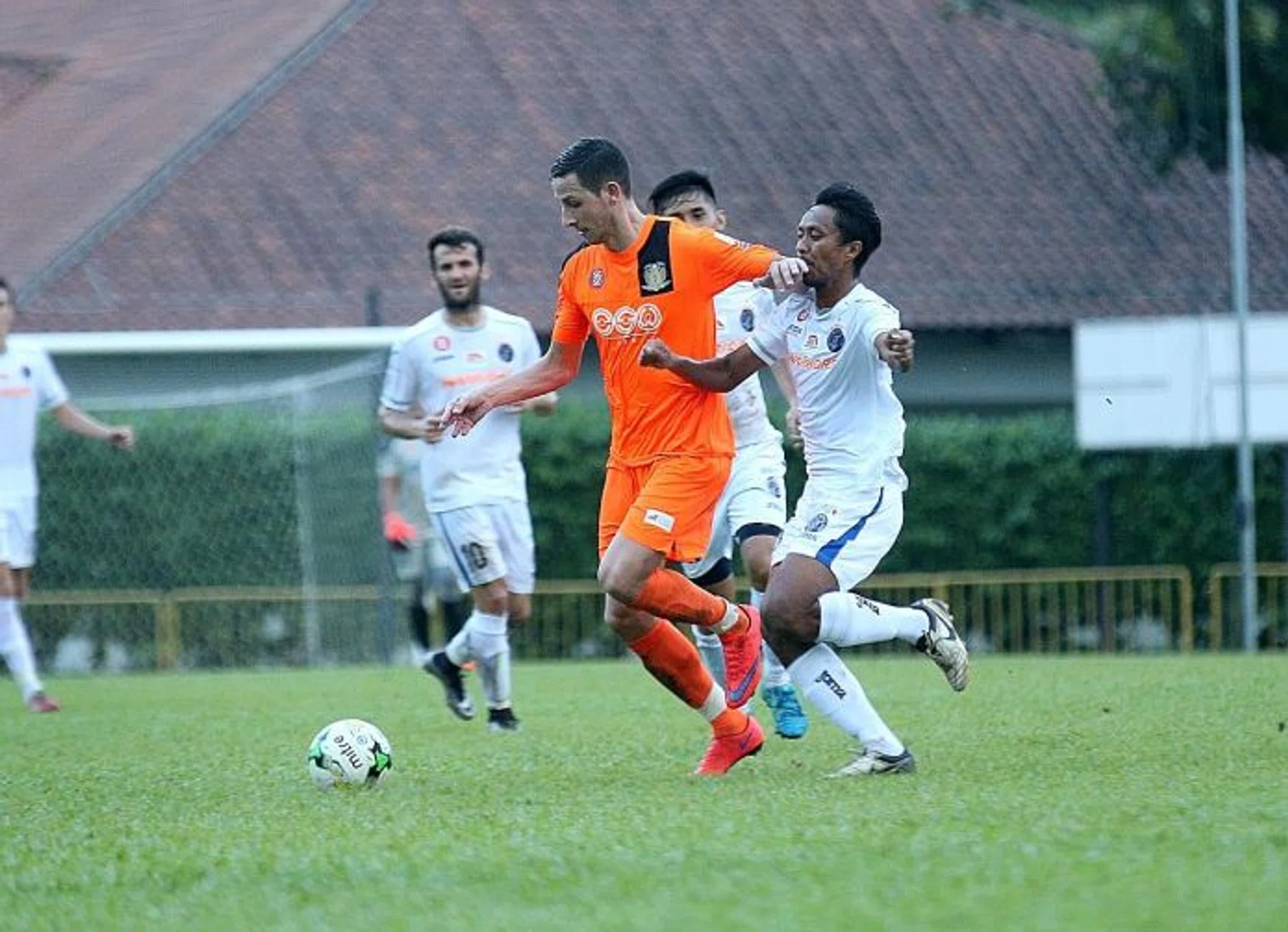 STIPE'S NEW STRIP: Hougang's latest signing Stipe Plazibat (in orange) in action during Friday's 3-2 friendly loss to Warriors FC. 