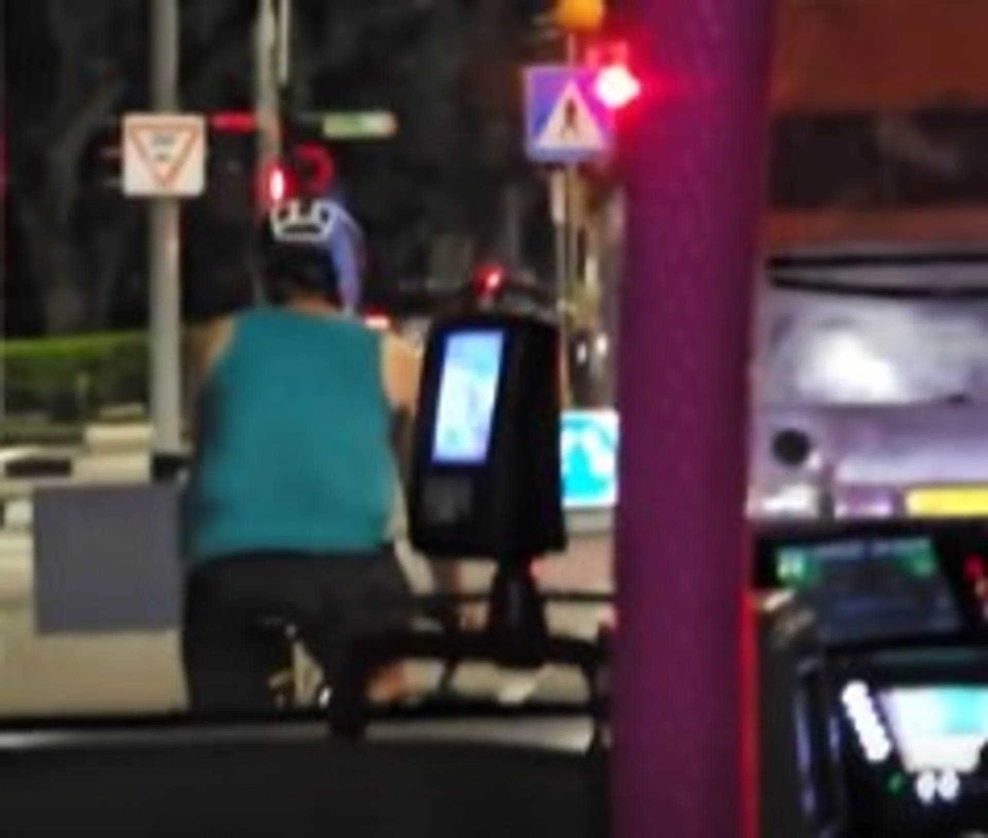 The cyclist can be seen pedalling leisurely while right in front of the bus.