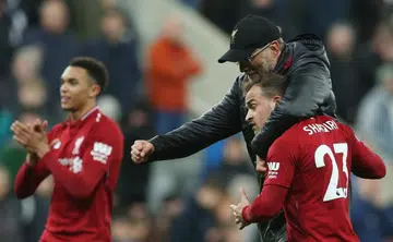 Liverpool keep pressure on City with late win against Newcastle