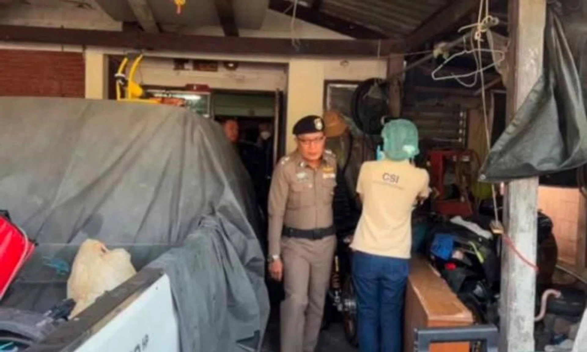 Police examine the house where a boy's body was hidden in a refrigerator, in Nonthaburi's Bang Bua Thong district, on Jan 6.