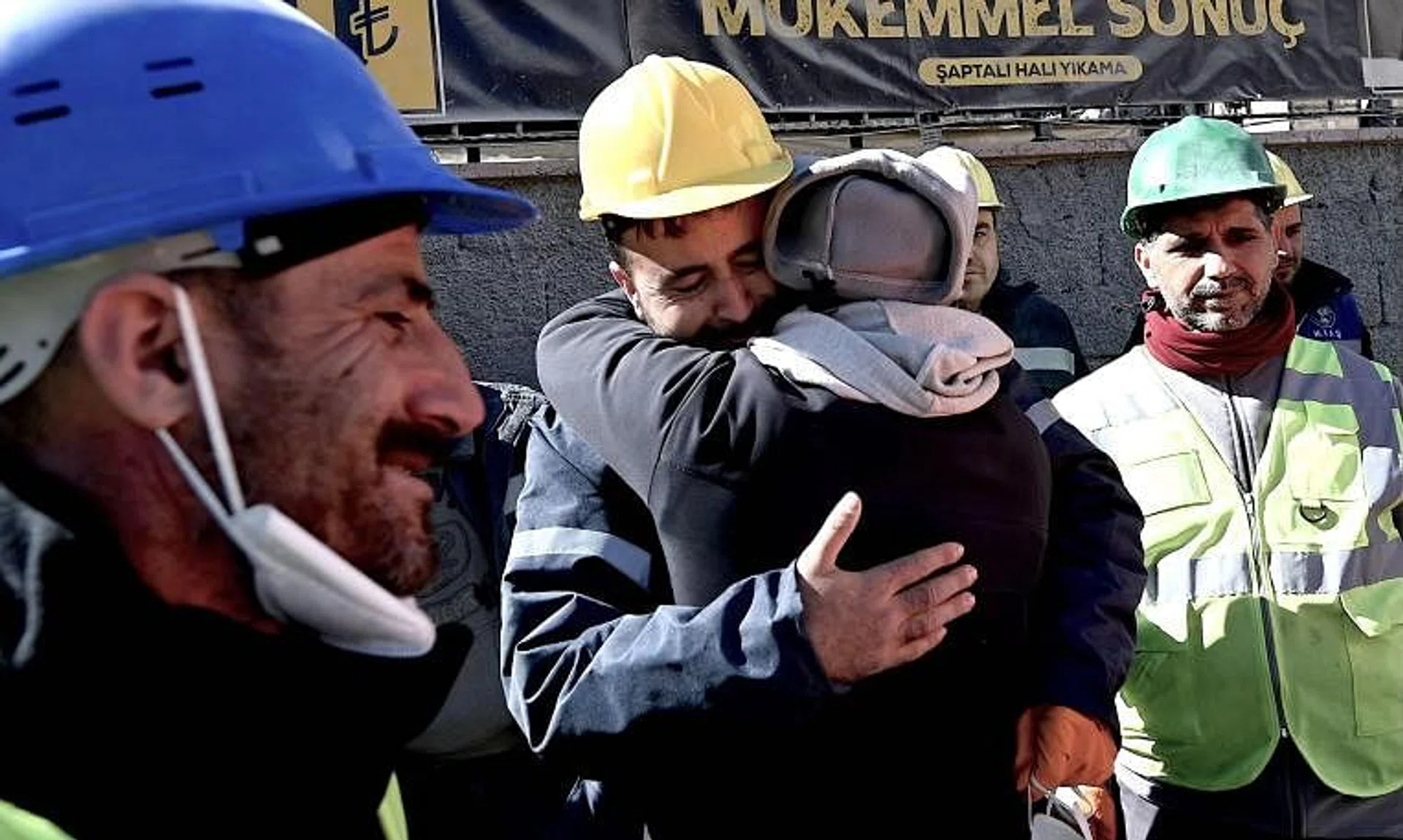 The uncle of the teenager reacts after she was rescued from a collapsed building.