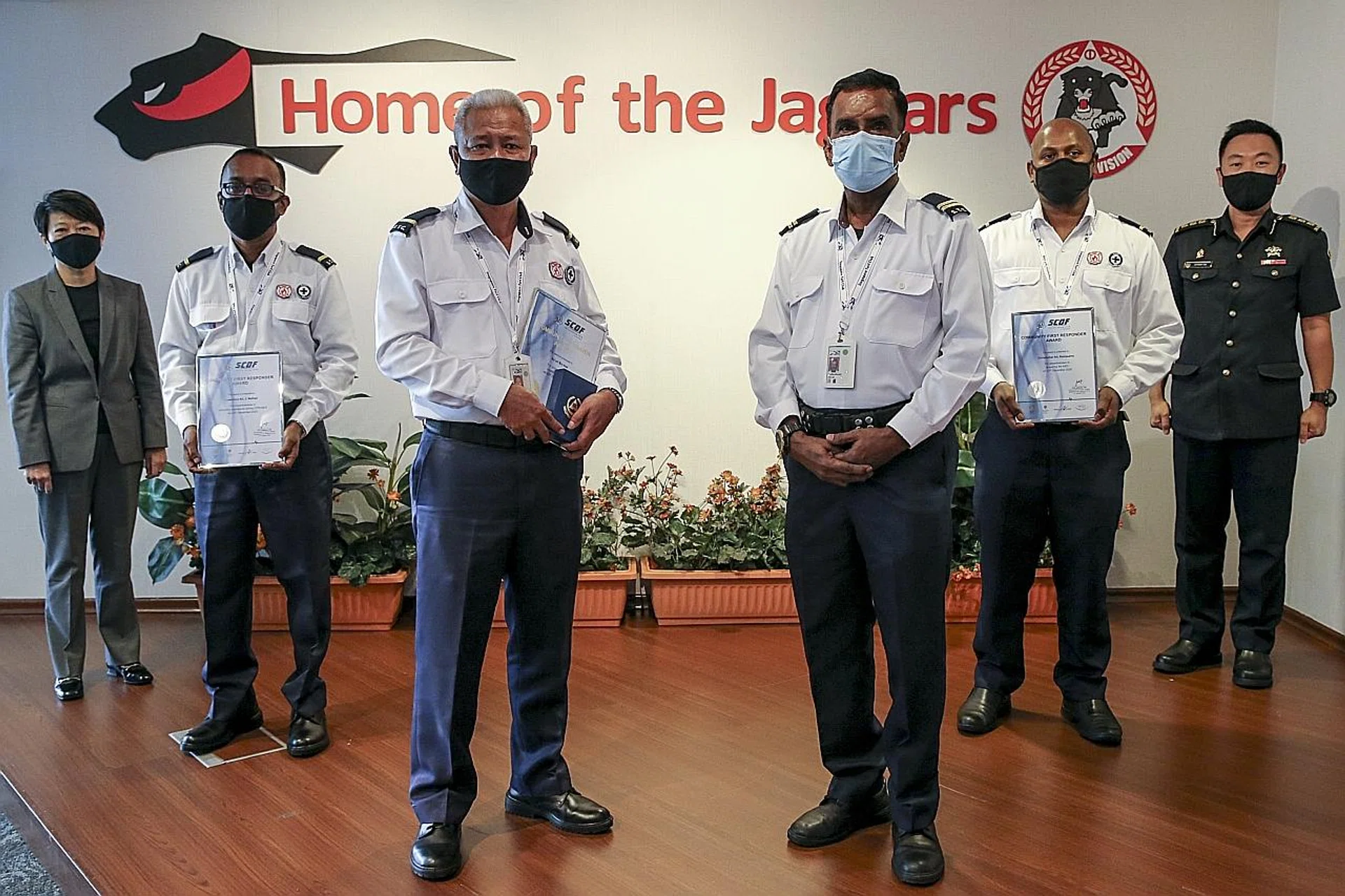 (From left) Singapore Turf Club chief executive Irene Lim, Mr Lawrence Nathan, Mr As'ari Awi, Mr Anthonisamy David, Mr Christopher Ramasamy, and SCDF Commander Anthony Toh at the presentation of their awards.