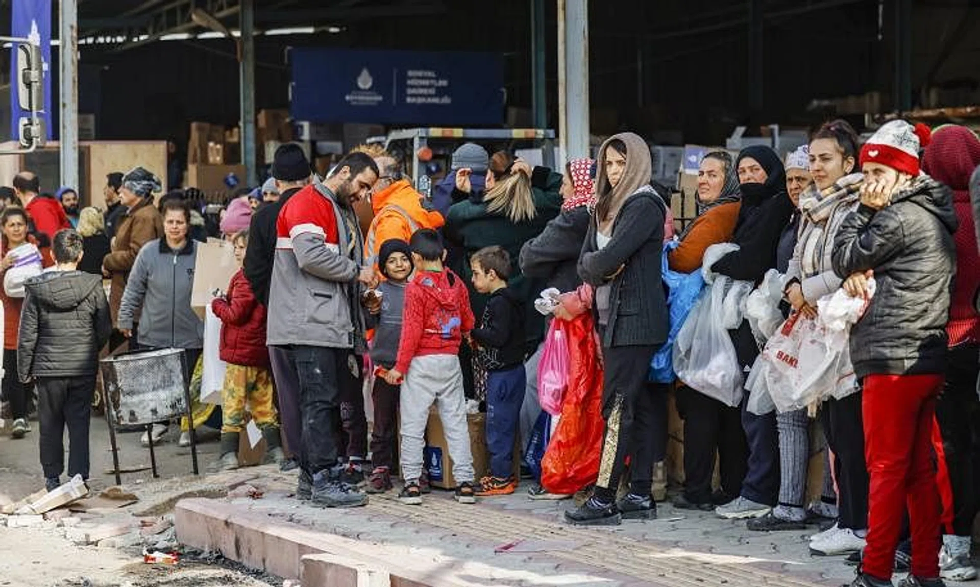 Residents queueing for humanitarian aid in Samandag, Turkey, on Sunday.