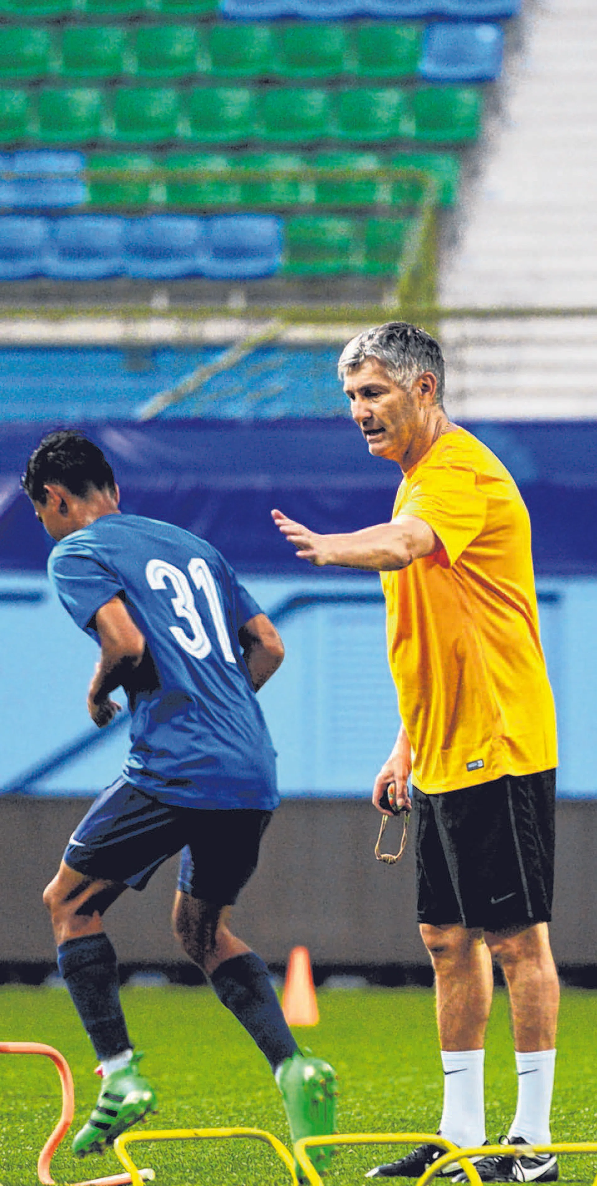 PAT ON THE BACK: Patrick Hesse (right) giving winger Shameer Aziq encouragement during his
first training session yesterday.