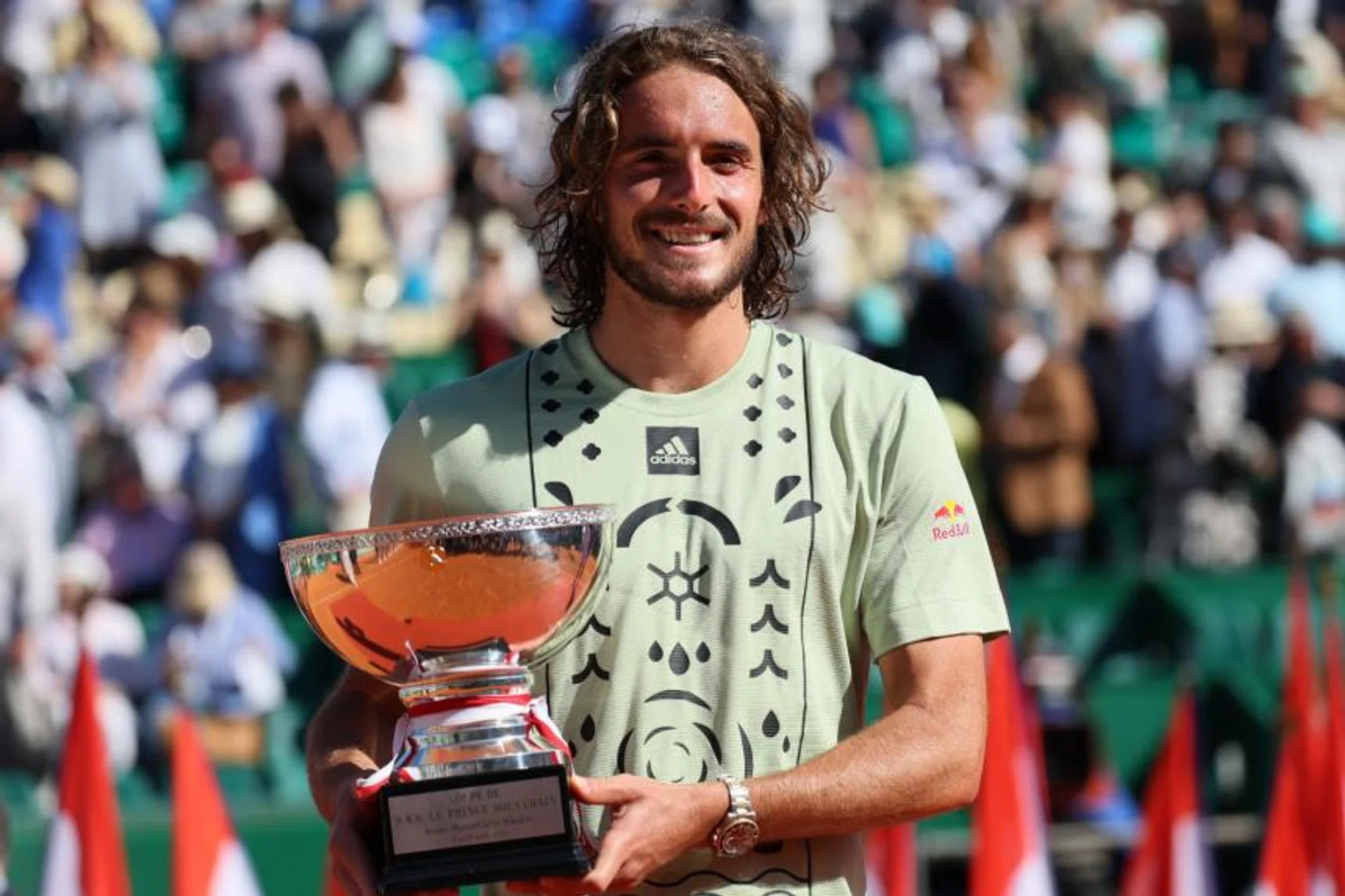Greece's Stefanos Tsitsipas celebrates with his trophy on April 17, 2022. 