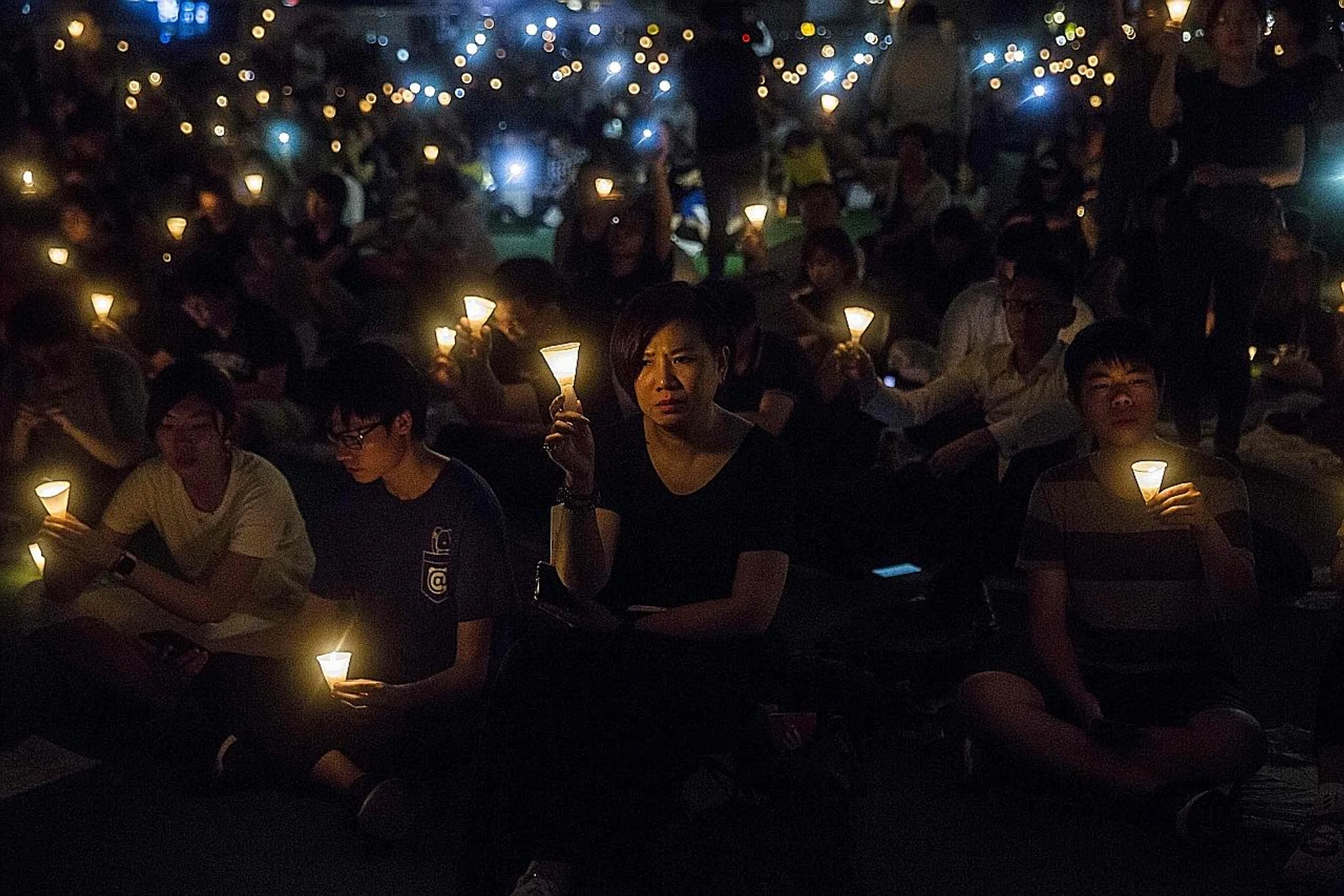People holding candles during a vigil in Hong Kong last year to mark the 30th anniversary of the 1989 Tiananmen crackdown in Beijing. This year, the police for the first time rejected an application of the annual vigil. 
