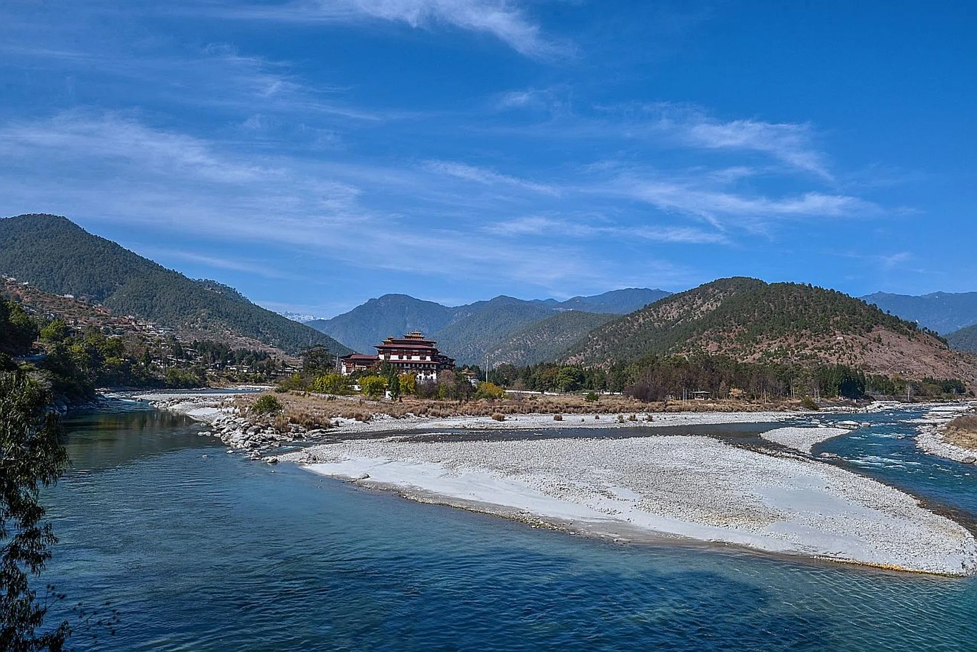 The Punakha Dzong (above), one of Bhutan's landmarks. Masked performers at the Dochula Pass festival. The icnonic Tiger's Nest. 