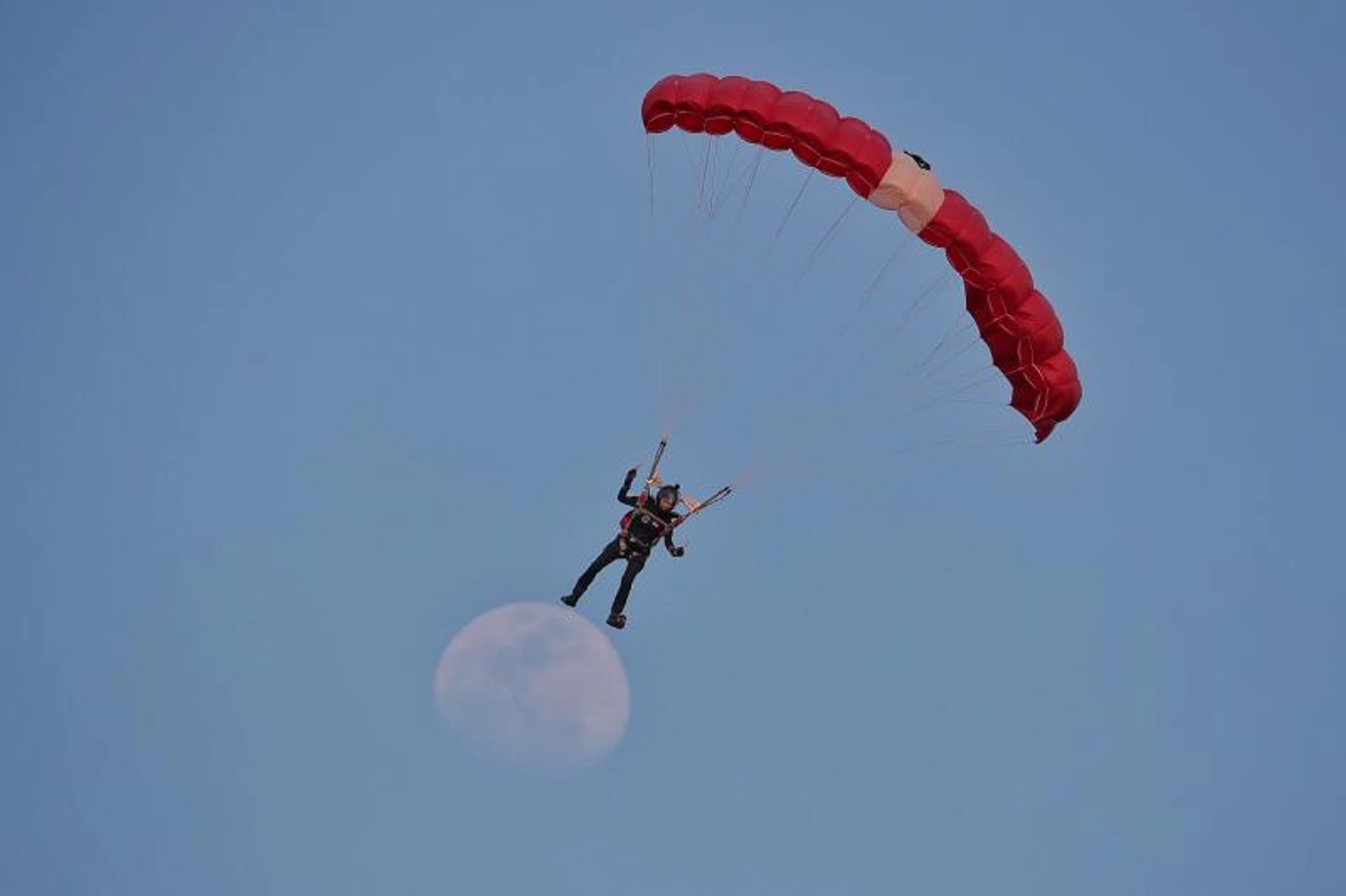 Red Lion Shirley Ng descends in a free-fall jump over The Float @ Marina Bay on Aug 9, 2022.