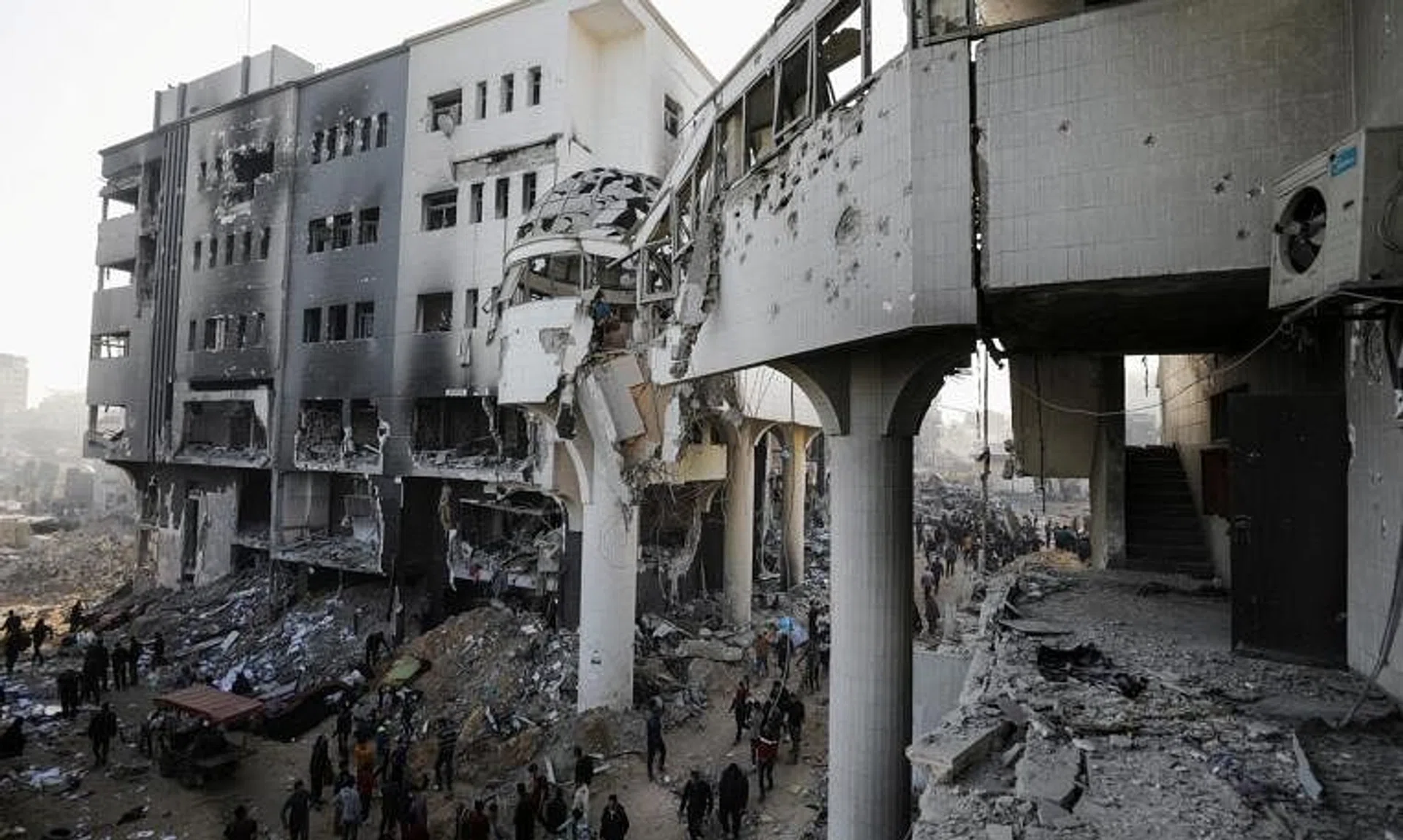 FILE PHOTO: Palestinians inspect the damages at Al Shifa Hospital after Israeli forces withdrew from the Hospital and the area around it following a two-week operation, amid the ongoing conflict between Israel and Hamas, in Gaza City April 1, 2024. REUTERS/Dawoud Abu Alkas/File Photo
