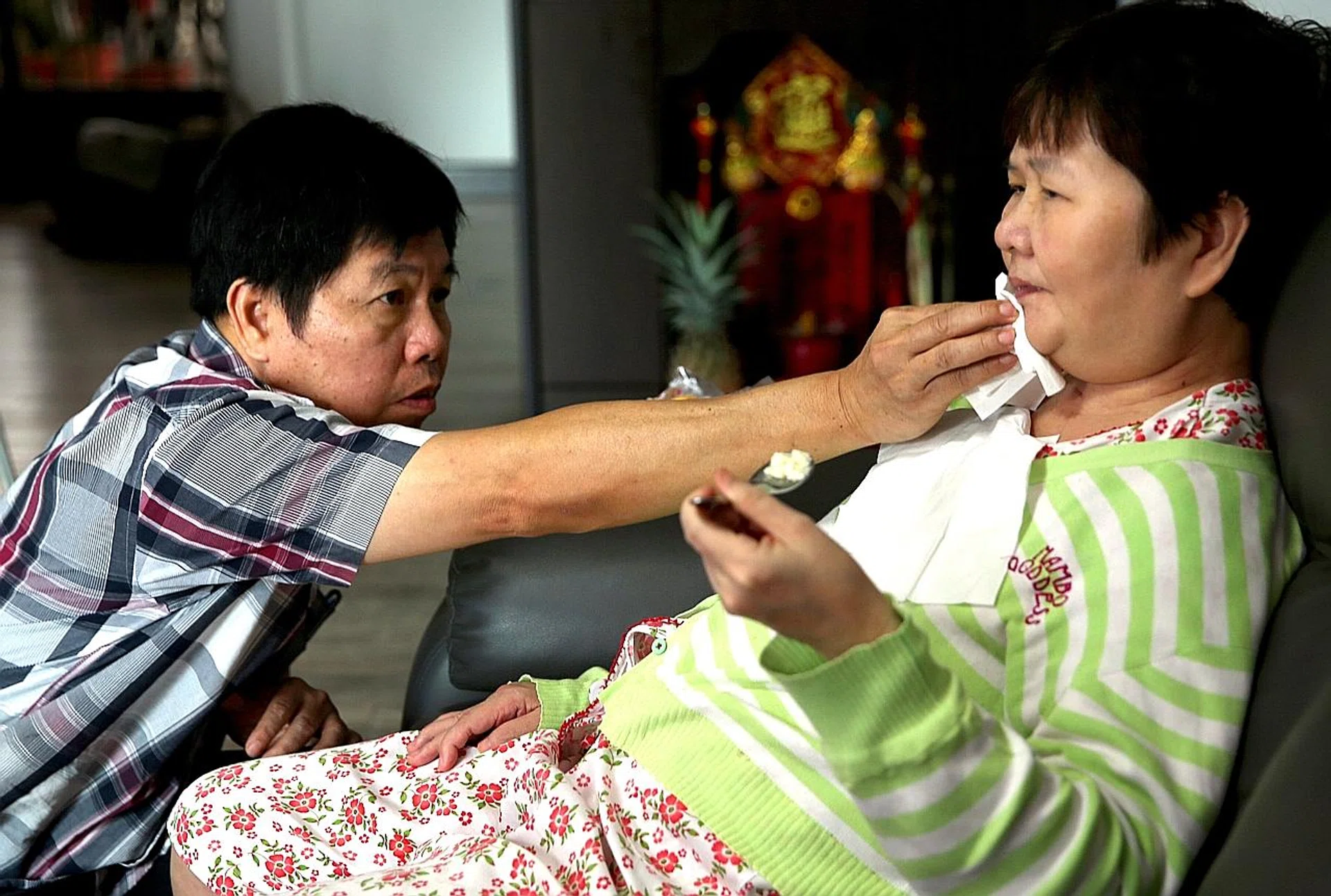 Madam Ang Liu Kiow (right) was left with severe brain injuries and is being cared for by her family, including her husband, Mr Leong Loon Wah (left). 