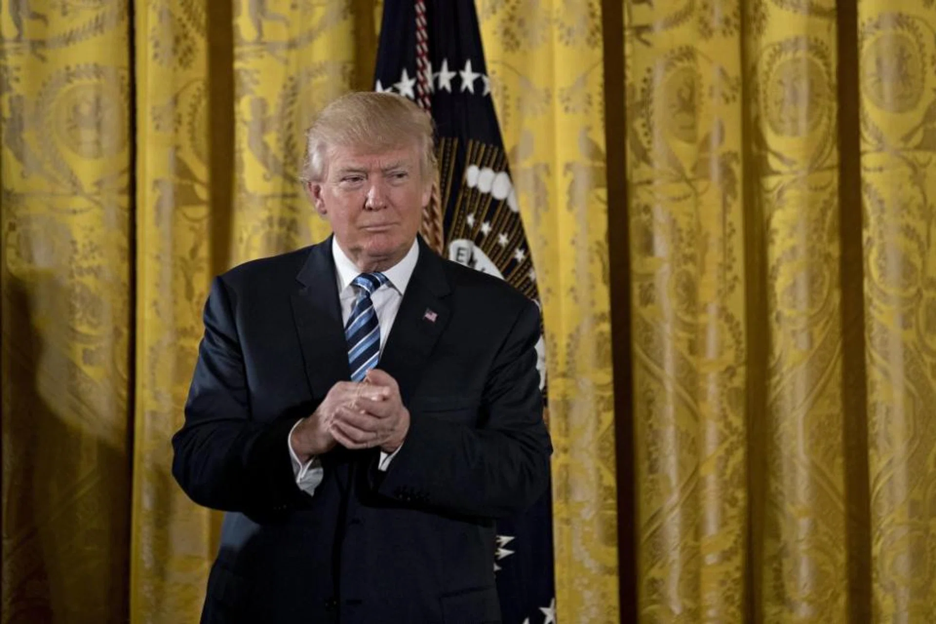US President Donald Trump listens during a swearing in ceremony of White House senior staff in the East Room of the White House in Washington, DC, USA, on 22 January 2017.