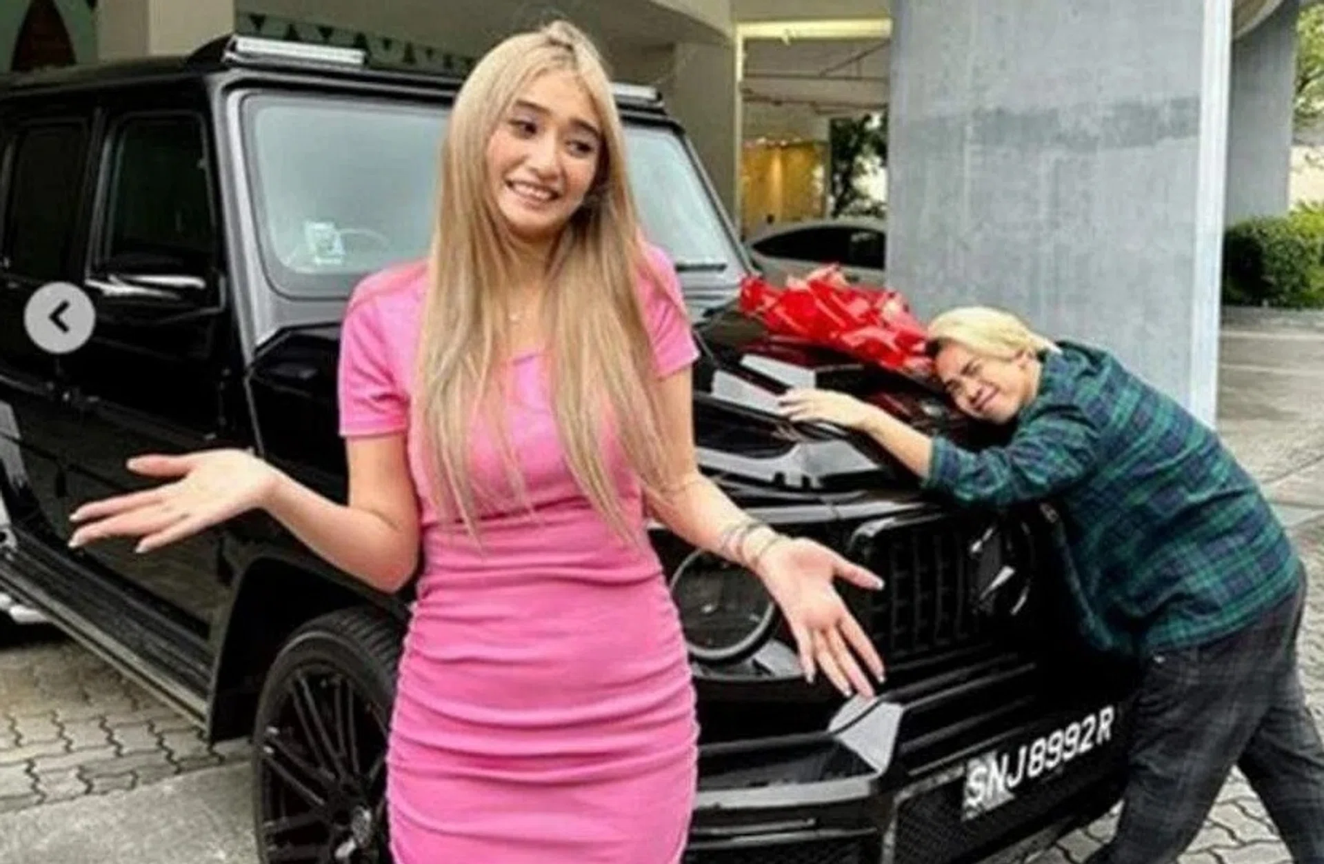Jianhao Tan (right) and Debbie Soon with the car she bought for him.