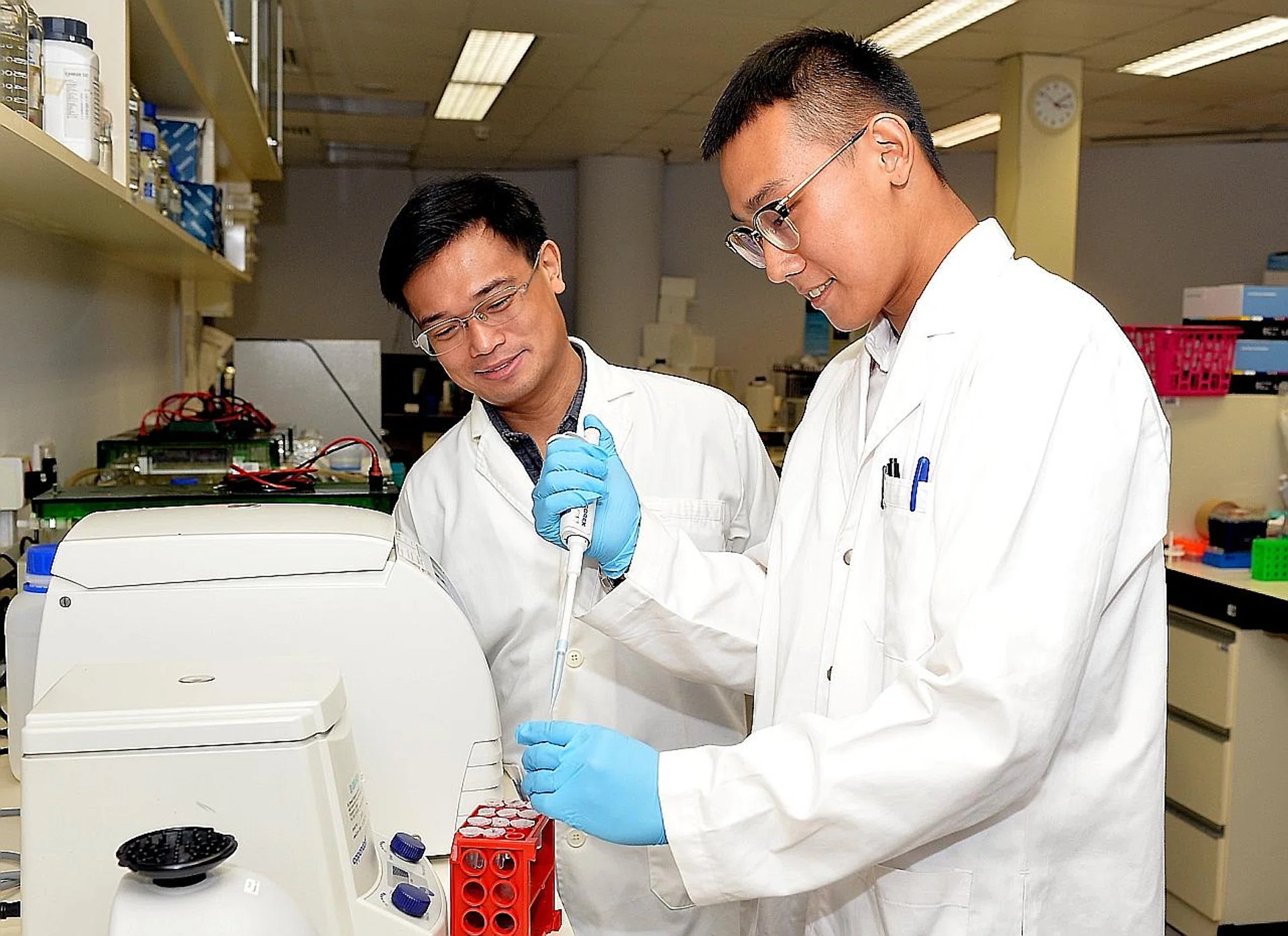 (From left) Dr Samuel Gan, a principal investigator, with Mr Ron Chiang. They both graduated from TP's biotechnology course. 