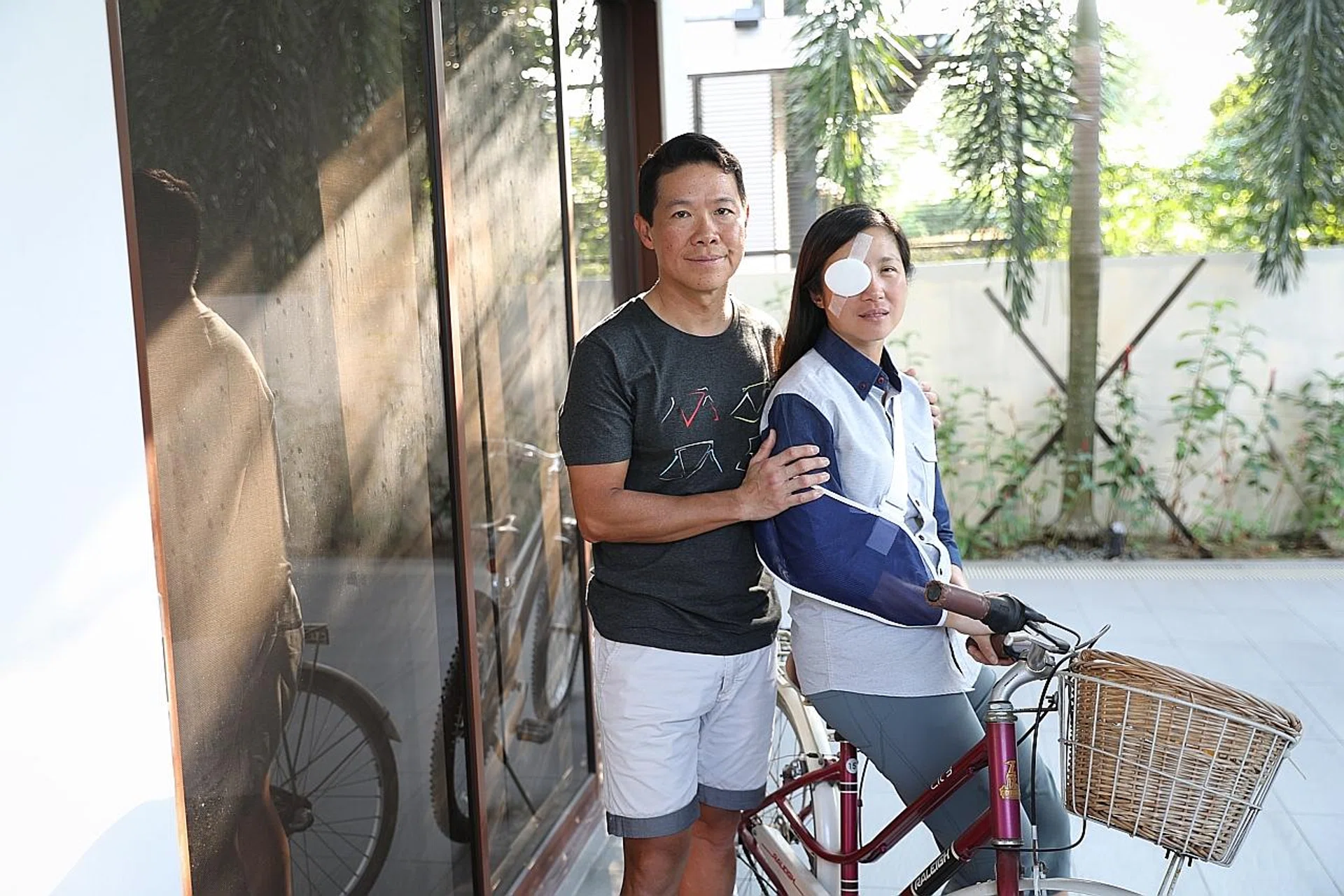 Dr Lynette Ngo (above, with husband Dr Hing Siong Chen) suffered severe injuries after she was hit by a cab when she was cycling along Braddell Road. 