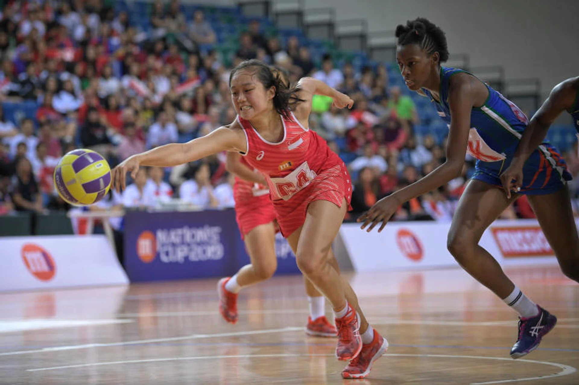 Singapore's Toh Kai Wei challenging for the ball with Namibia's Mwale Mulenamaswe.
